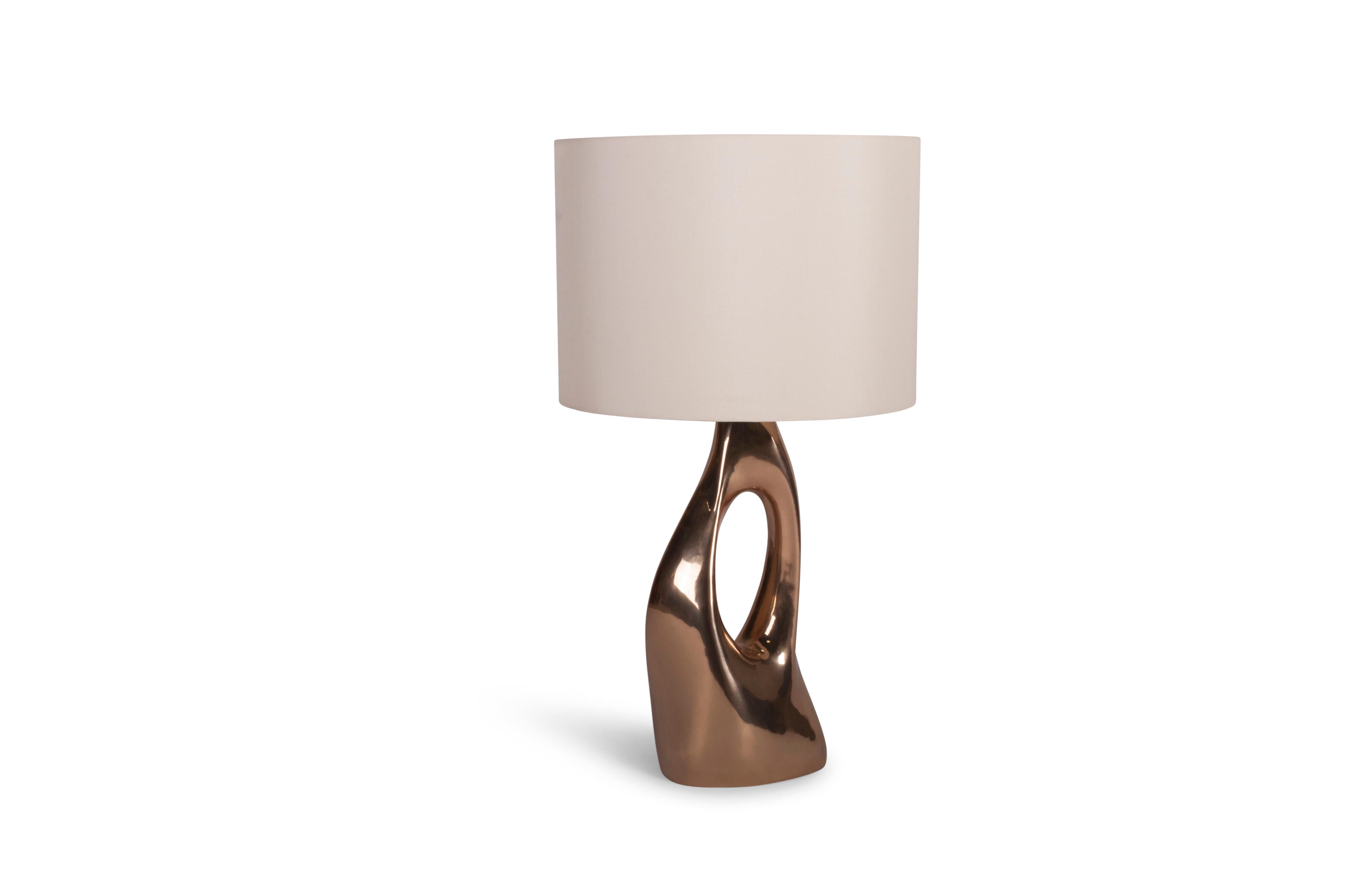 The Helix table lamp offers a unique and modern look for luxury homes. With its contemporary design, this table lamp is sure to add a touch of elegance to any space. Available with either a round or oval shade, you can choose the option that best