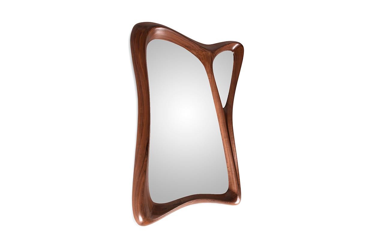 Jolie mirror is made out of solid Walnut wood with unique form. 
jolie mirror mounts with French clip. 

Jolie mirror available in different finishes and custom sizes. 

Amorph is a design and manufacturing company based in Los Angeles, California.