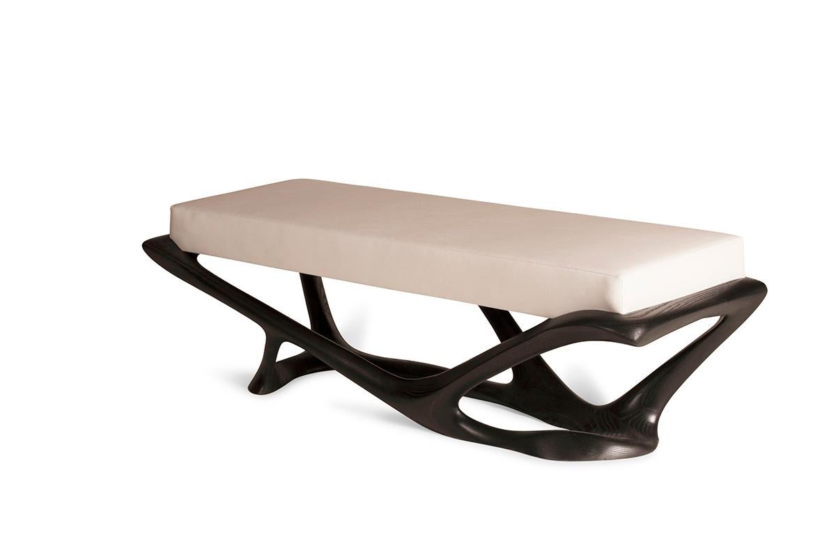 Amorph sculptural Nala bench in solid ash wood with ebony stained finish and white leather upholstery.
Dimensions: 60”L 23”W 18”H

It is available in different finishes and custom sizes. 

About Amorph: Amorph is a design and manufacturing company