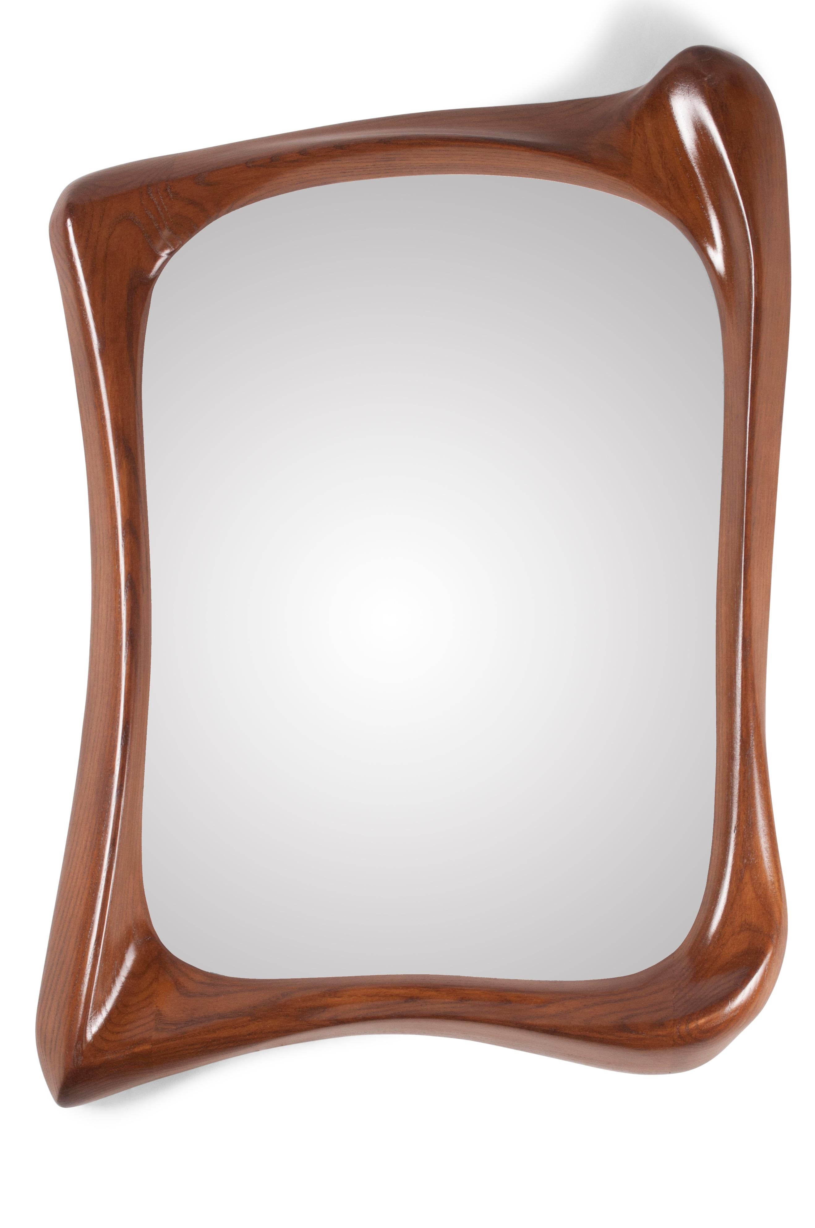 Narcissus Mirror with Walnut stained finish on Ash Wood.

About Amorph: 
Amorph is a design and manufacturing company based in Los Angeles, California. We take pride in hand crafted designs connected to technology to create sophisticated, design