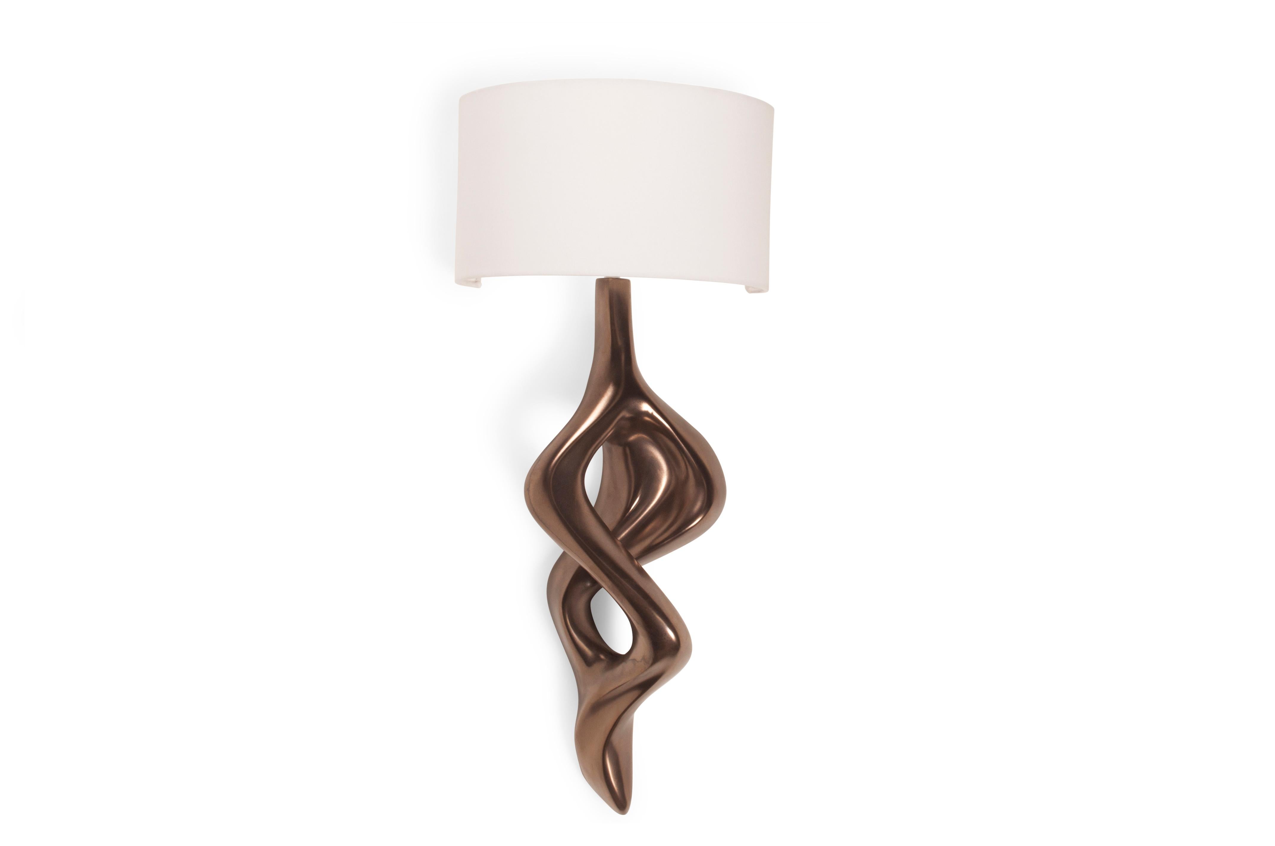 Nomi sconce is carved from solid wood walnut with half a drum shape shade. Shade dimensions: 12