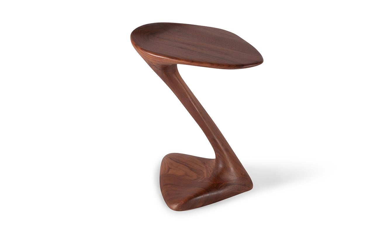 sculptural side table with unique and dynamic shaped designed and manufactured by Amorph. 
Stained color: Graphite walnut 
Dimension: 19.25