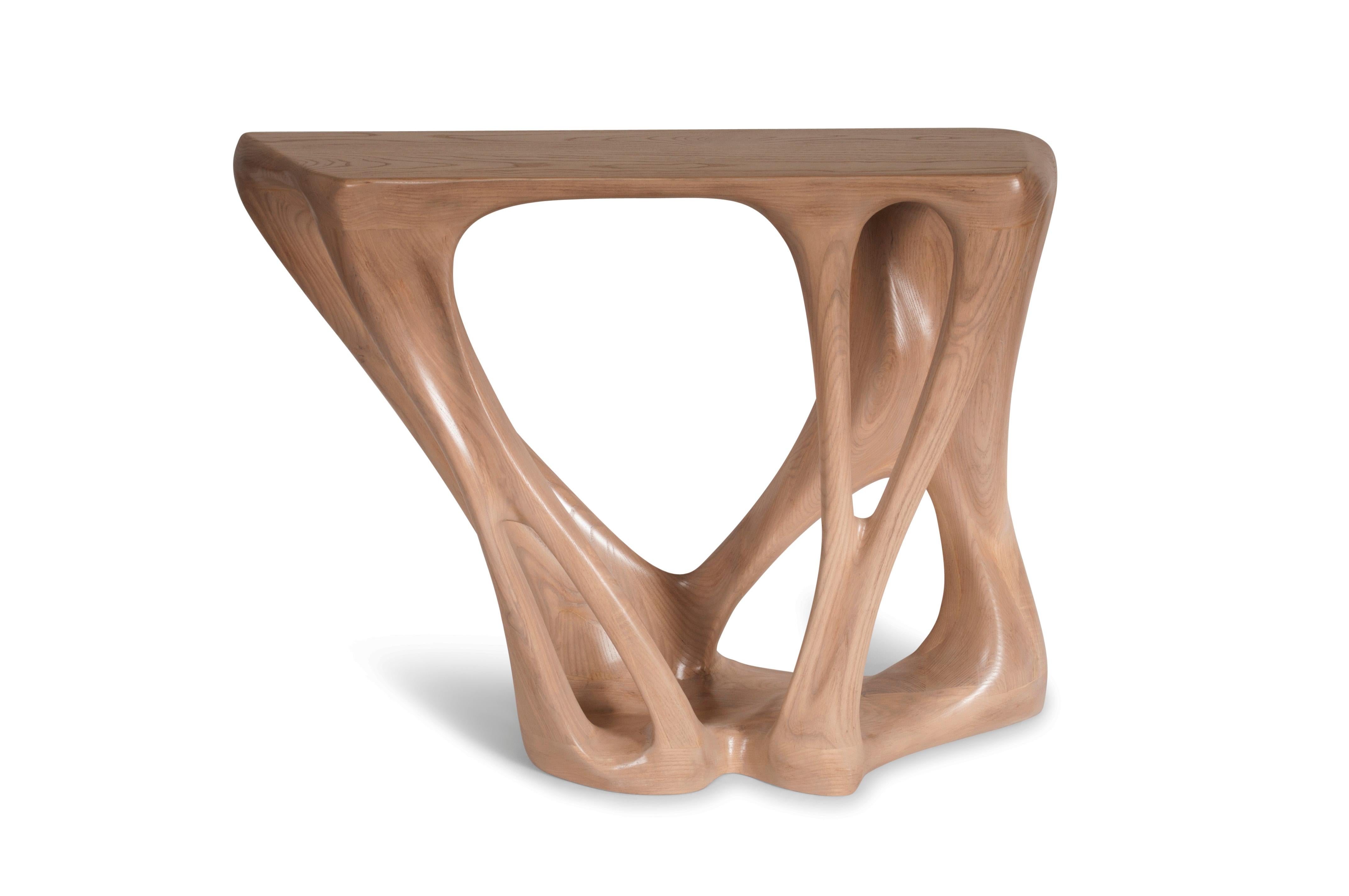 Petra console table is a stylish futuristic sculptural art table with a dynamic form designed and manufactured by Amorph. Petra is made out of solid ash wood stained with satin finish. By the nature, the ash wood grain’s look would be slightly