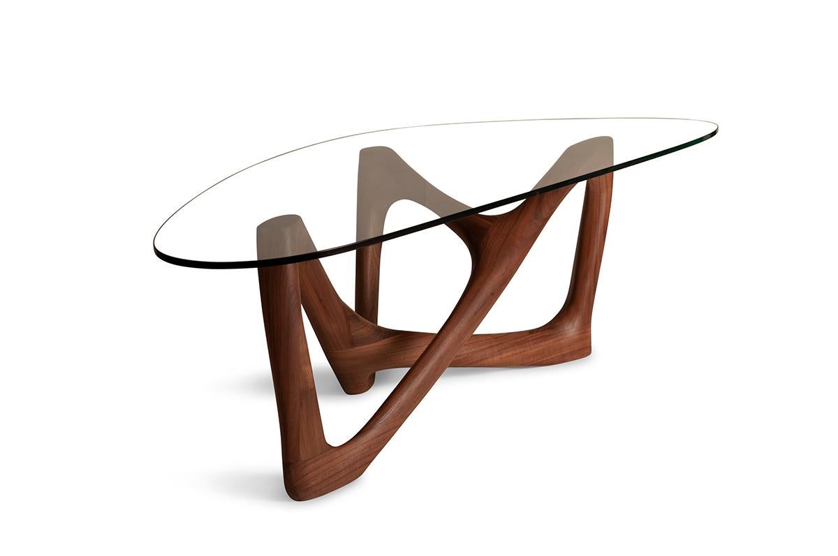 Walanty coffee table is solid walnut. 
Measures: Base: 43” L 17 1/4” W 18”H
 Glass: 62” W 27” D 1/2” H

About Amorph: 
Amorph is a design and manufacturing company based in Los Angeles, California. We take pride in hand crafted designs connected to