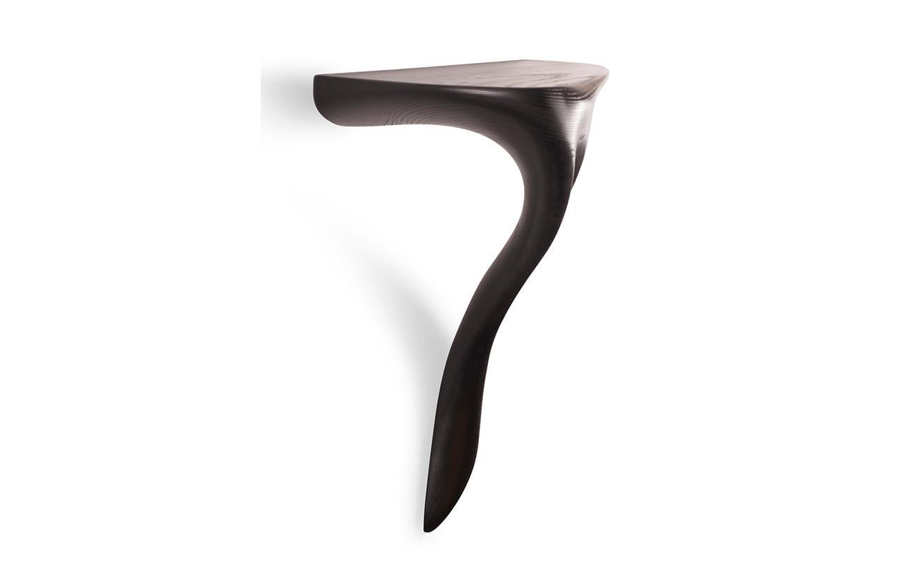The Yena console table is a stylish and luxurious addition to any home. Its wall-mounted design and organic shape form make it a unique and eye-catching piece. The top of the table can be customized with a stone finish, allowing interior designers