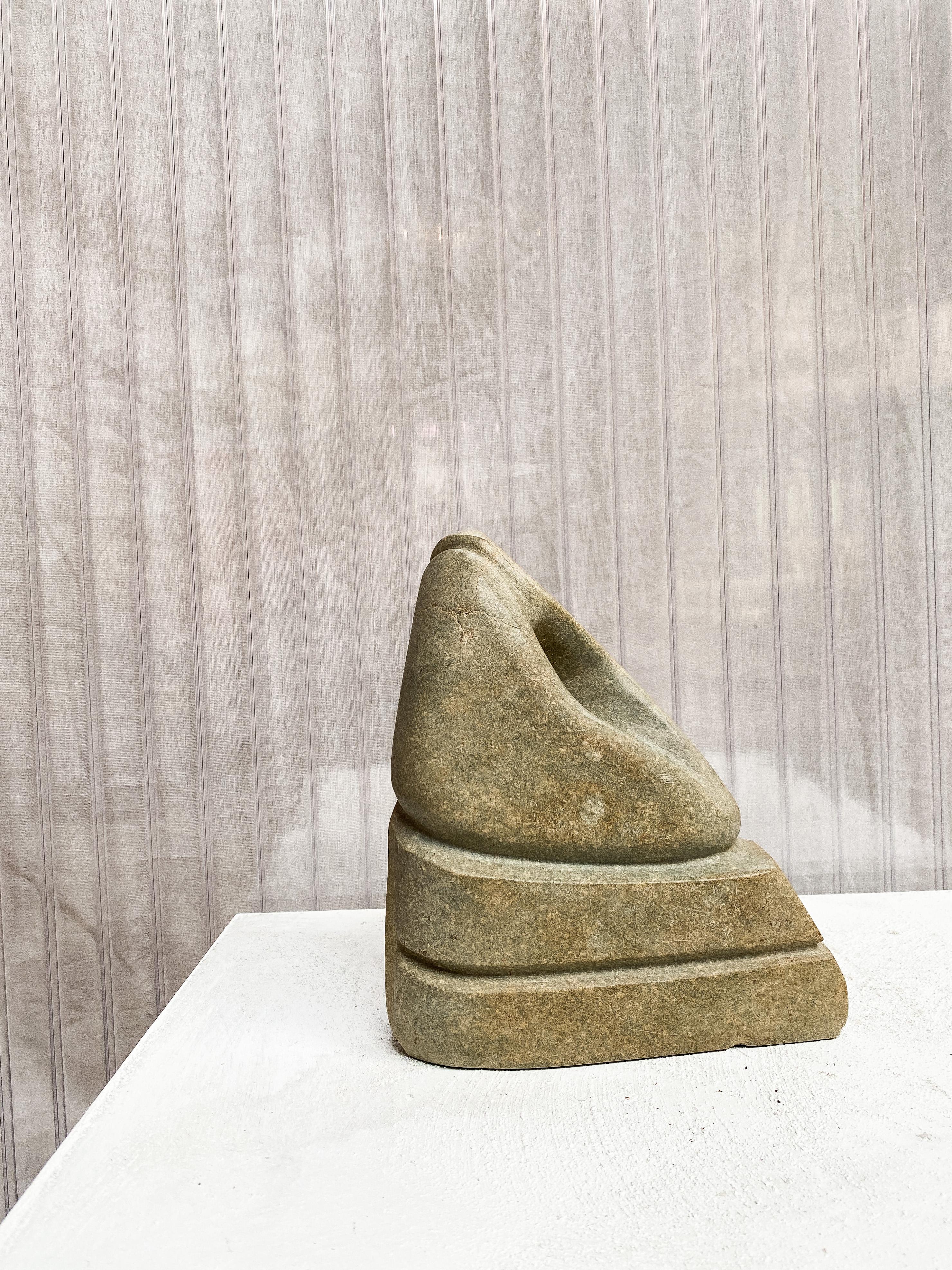Interesting modernist stone sculpture in an organic abstract shape. Green & greenish toned stone. 
The piece is interestingly carved on all sides, making it a beautiful freestanding sculpture. Highly decorative and subtle piece, fitting for any