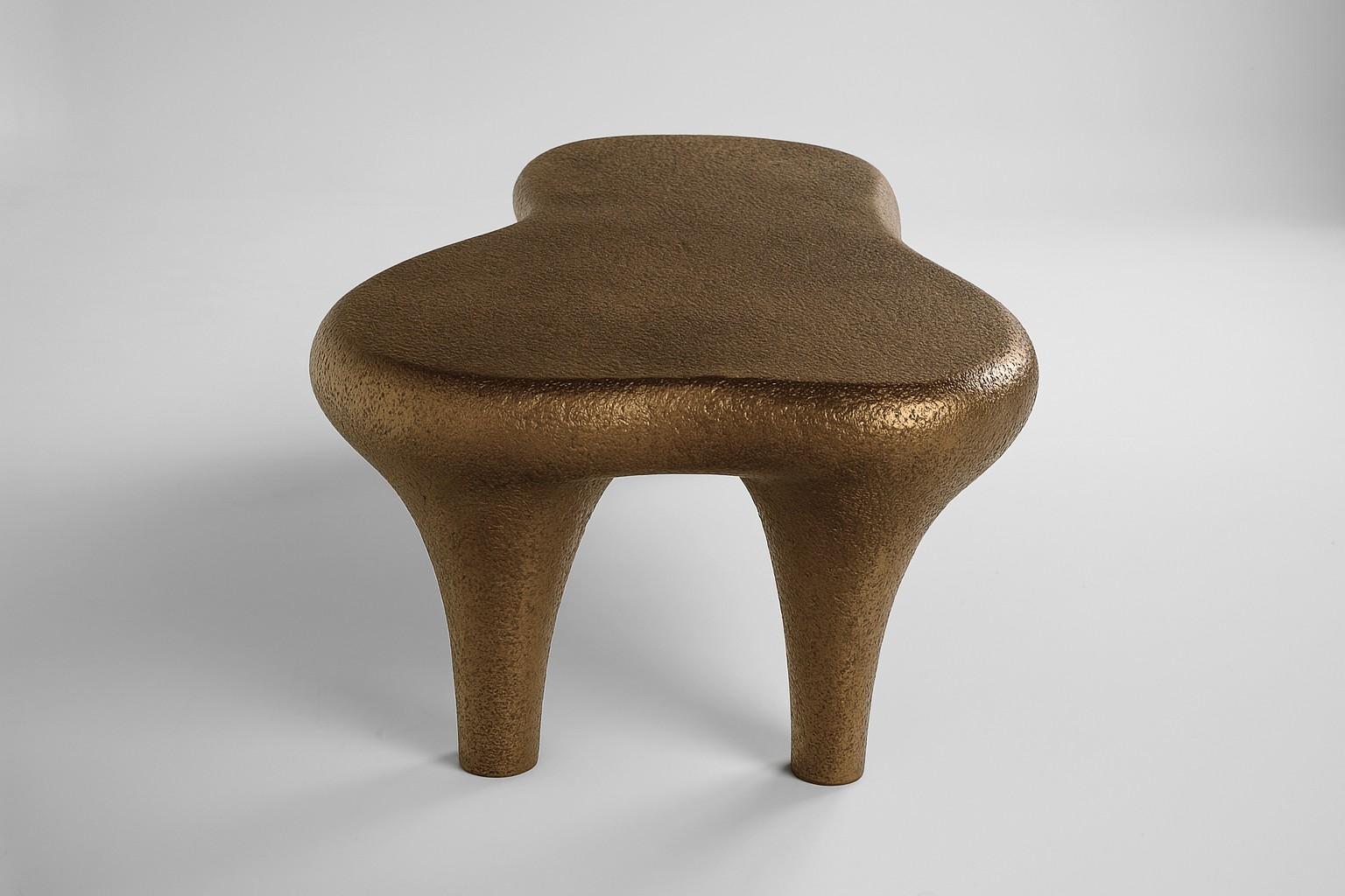 The Golem table is designed in a shape inspired by organisms in their amorphous state when they seamlessly blend into their surroundings.
The fiberglass reinforced resin texture used to create the table recalls the biomorphic design era. The
