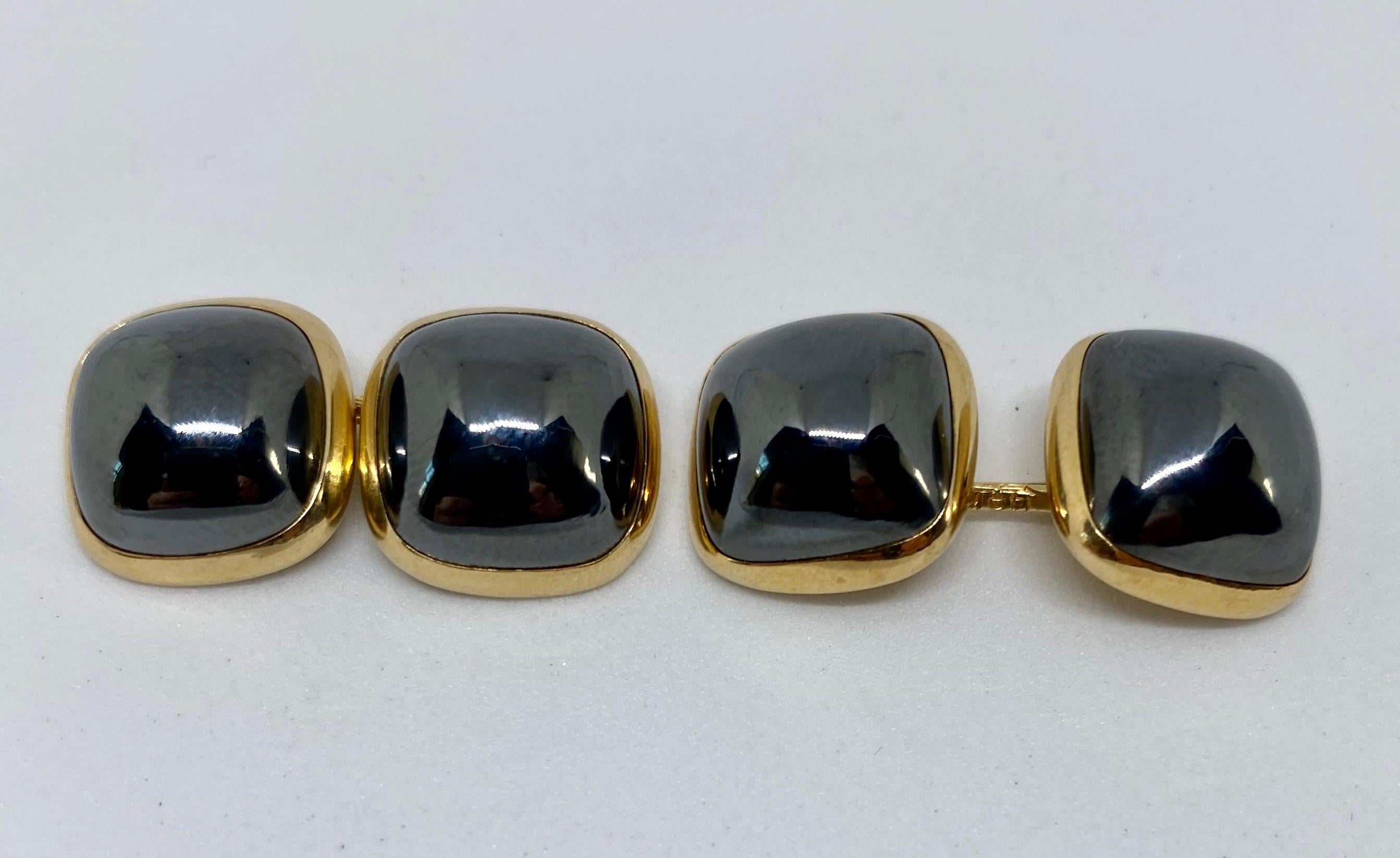 A superb dress set featuring double-sided cufflinks and three matching shirt studs made by Larter & Sons and retailed by Amos Sulka. 

Cufflinks have four square sugarloaf-cut cabochon hematites set in 14K yellow gold and measure 13.5mm on each