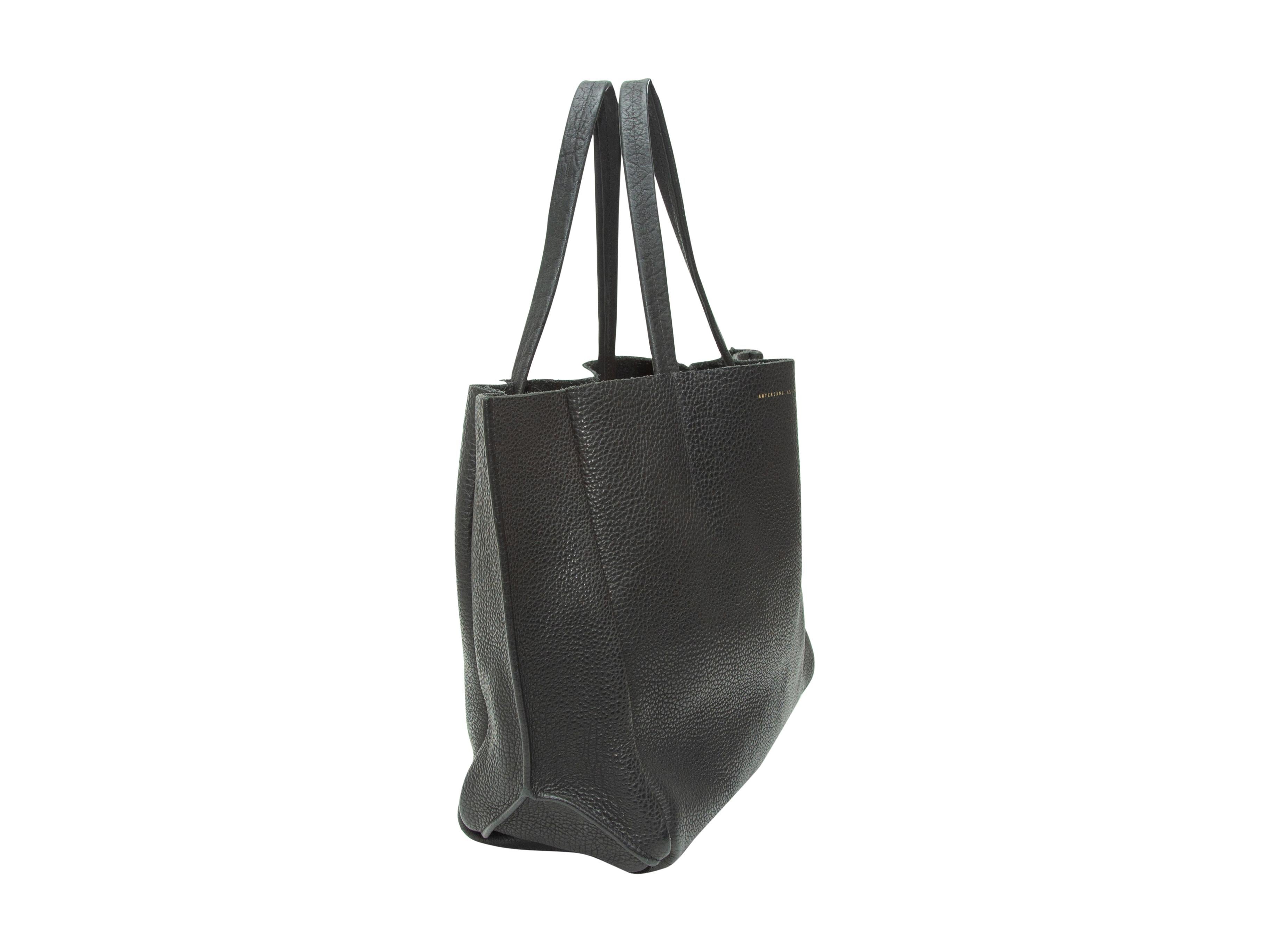 Product details: Black leather tote bag by Ampersand As Apostrophe. Tonal stitching throughout. Dual handles. 14