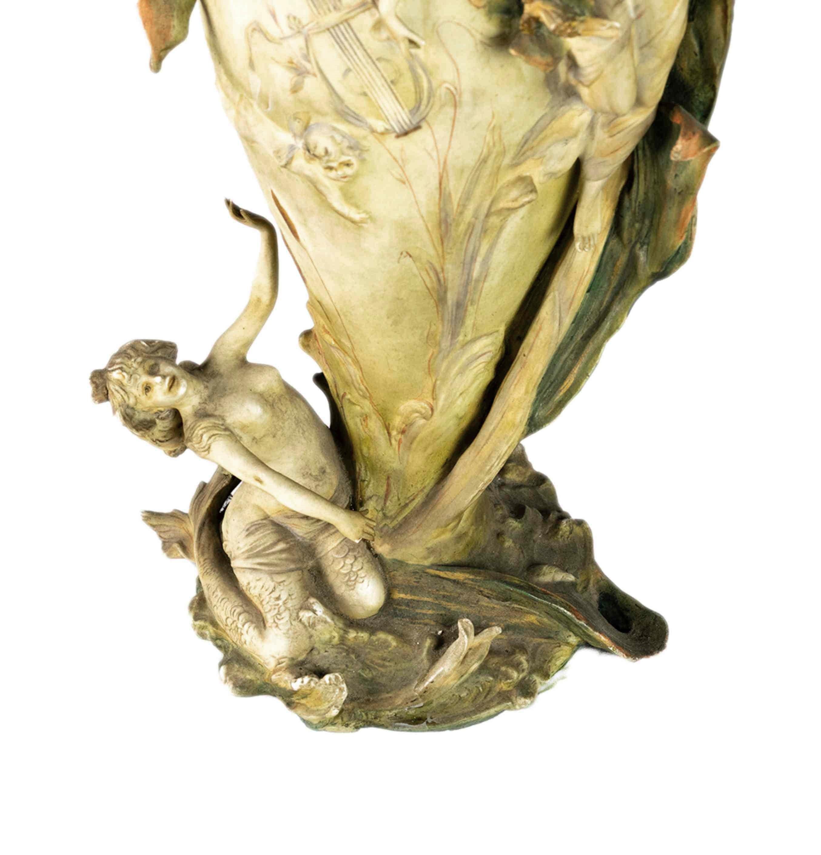 An amazing Jugendstil Style amphora from Rudolstadt, Thuringia hailing from the Triebner Ens Manufacture and the artist Karl Ens Volkstedt. Vase decorated with a iris flower form neck and reclining maidens in the upper and lower sections. Maker's