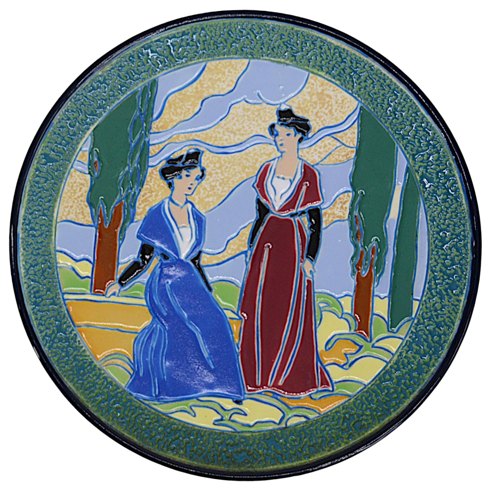 Pair of Art Deco ceramic wall plates by Amphora, circa 1930. Provencal design. Decor of young Provencal girls in a landscape typical of the Art Deco years. Young women are dressed in the fashion of Arles, Fontvielle, Saint-Remy-de-Provence, Nimes,