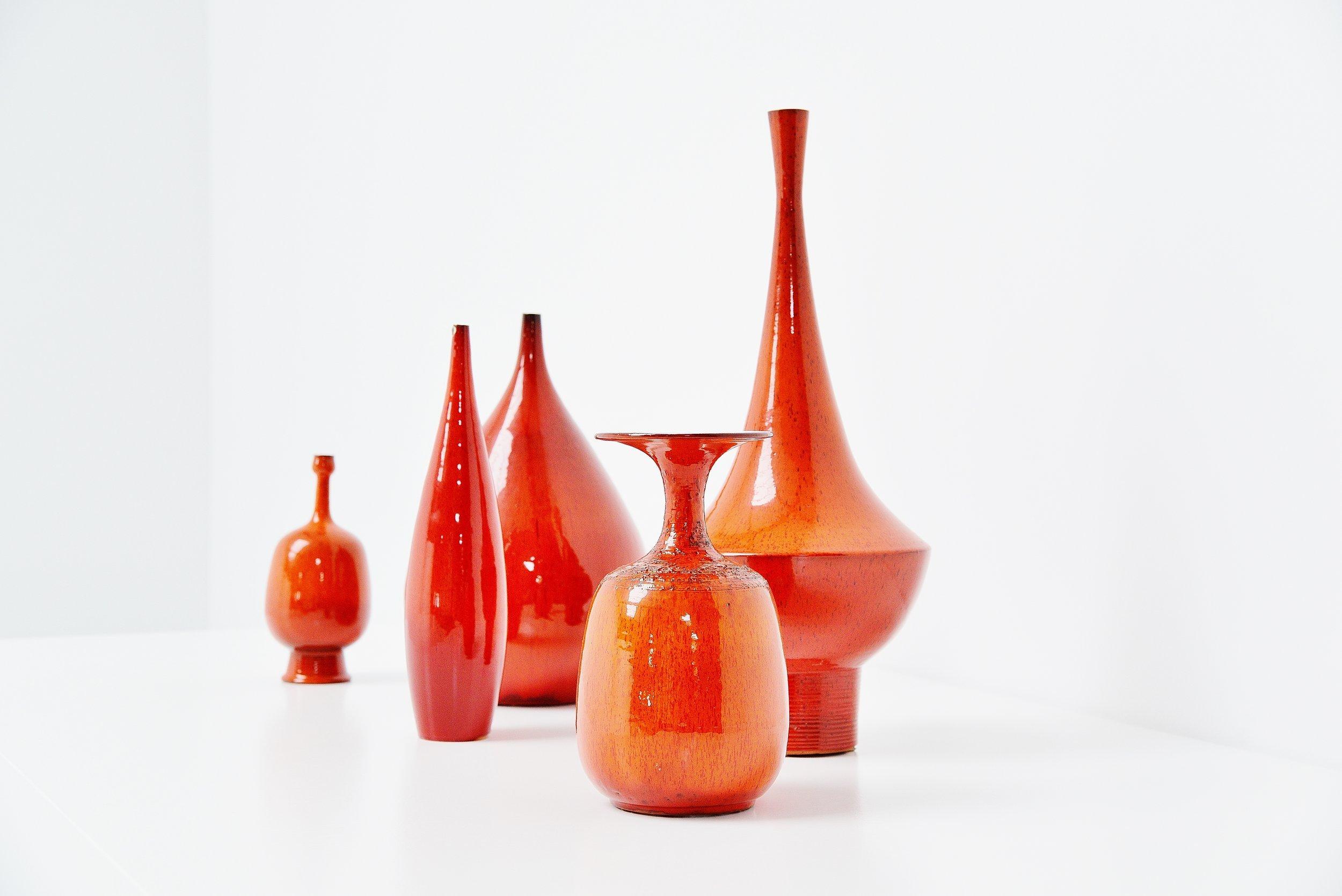 Highly decorative and very large sized ceramic vases set (5) designed by Rogier Vandeweghe and manufactured by Amphora, Belgium 1963. These vases have an amazing unusual shape and nice red/orange glaze and would look highly decorative in any modern