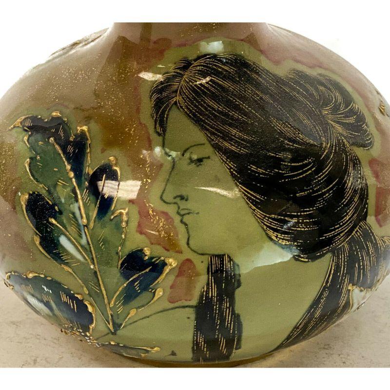 Amphora RSTK enamel pottery vase portrait of a beauty Art Nouveau, circa 1900.

The central area depicts an Art Nouveau beauty with gilt accents to her hair strands. Leaf and floral accents throughout. Amphora RSTK mark to the