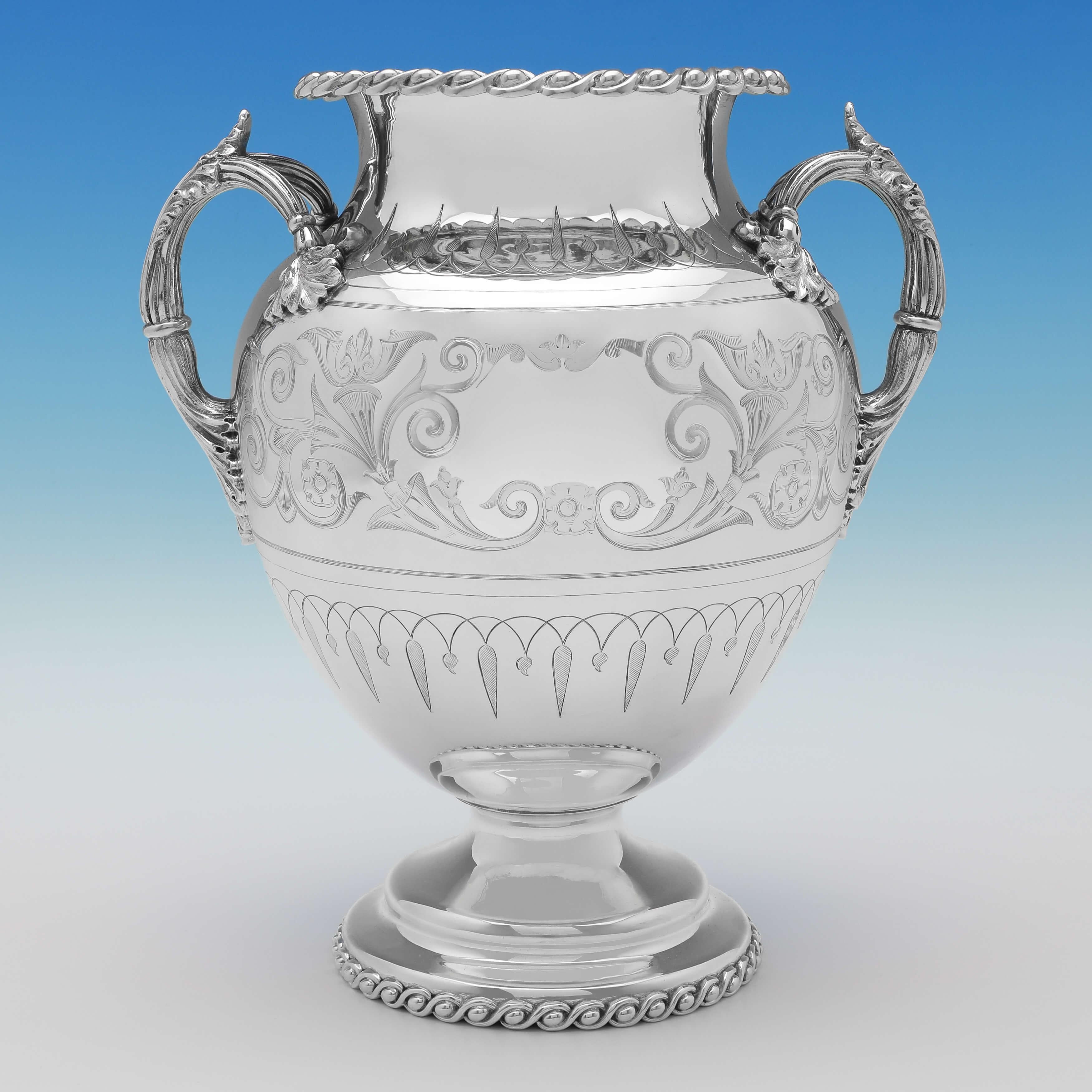 Carrying an old plate mark for 1855 by Thomas Bradbury & Sons, this very stylish, neoclassical revival pair of antique silver plated wine coolers, are shaped to resemble Greek Amphora, and feature stunning engraving throughout. Each wine cooler