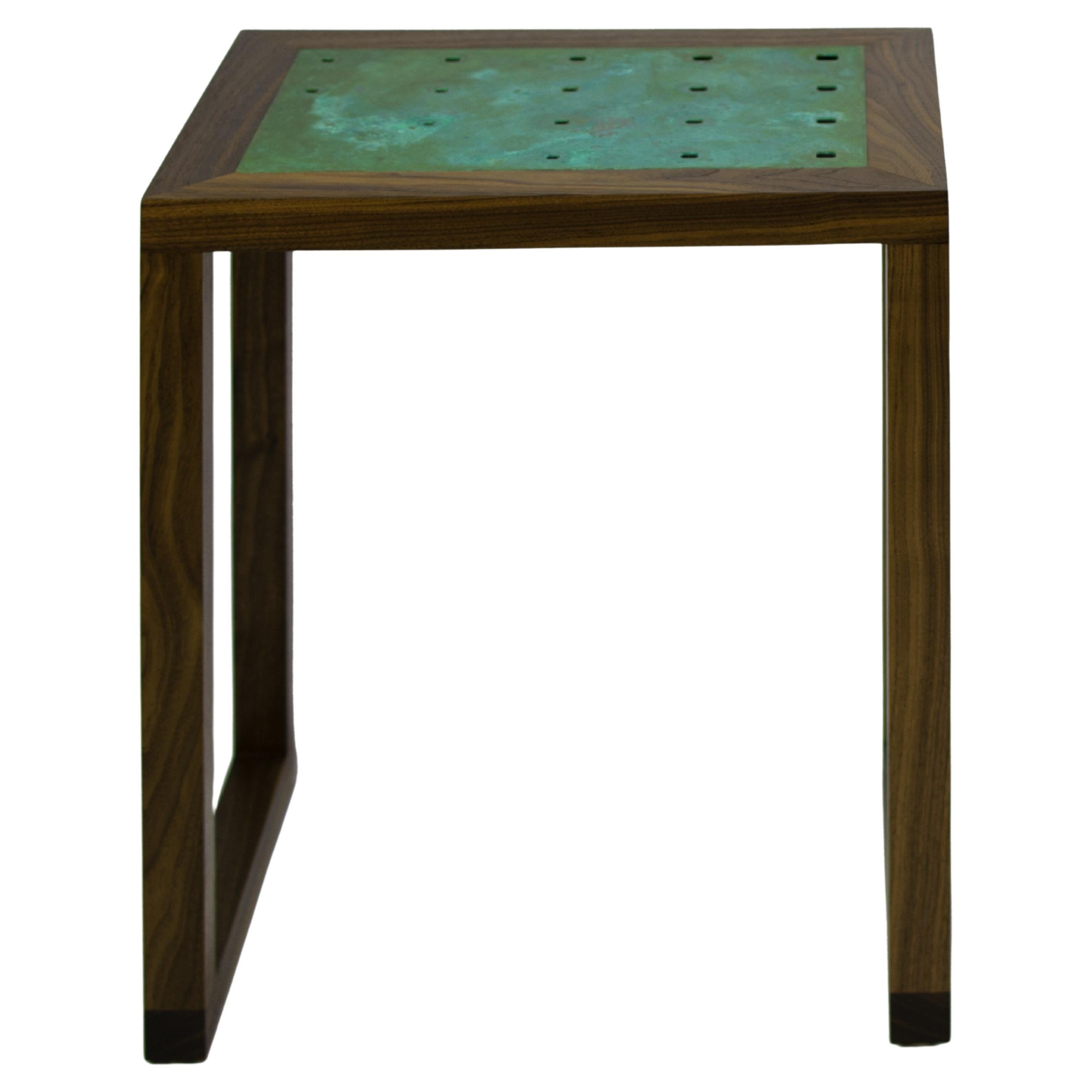 The Amplitude end table features a solid walnut frame inlaid with a patinated copper panel. The clean geometric lines and gradating hole pattern produce a simple yet dynamic form, well suited to highlight the natural beauty of the materials. Please