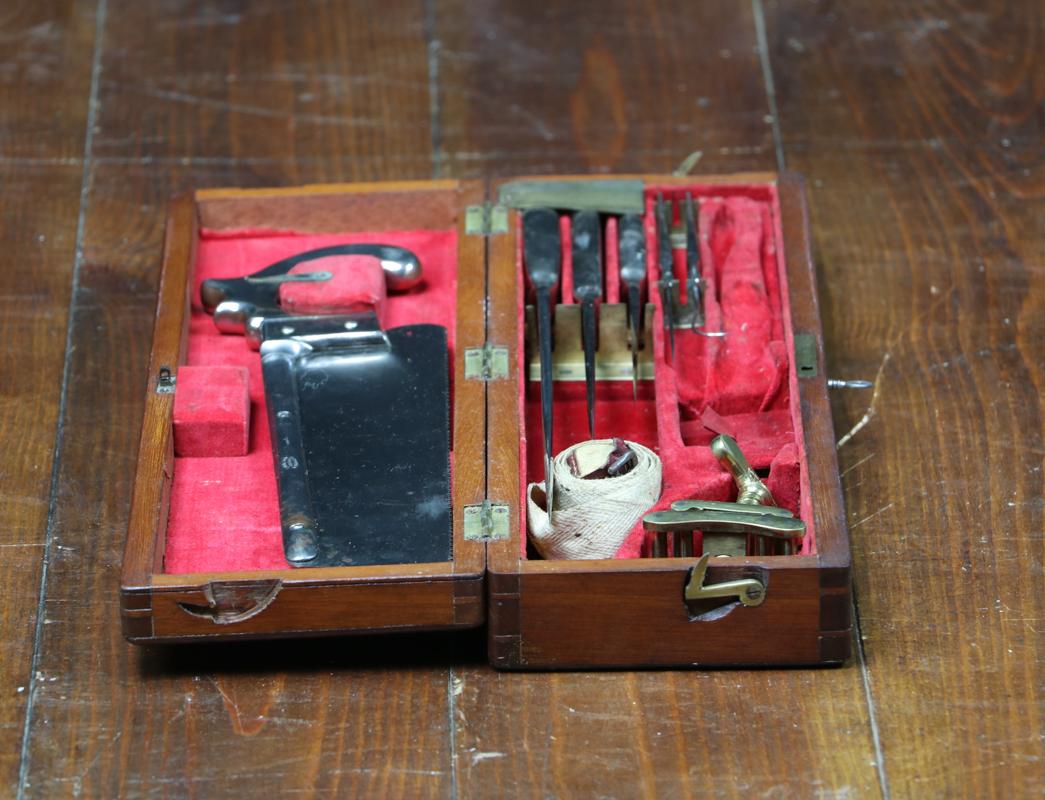 Amputation kit with key.

With almost all its tools (2 missing small things).

Saw, scalpel, knives, hook, tourniquet.

Compartment for needles.


 