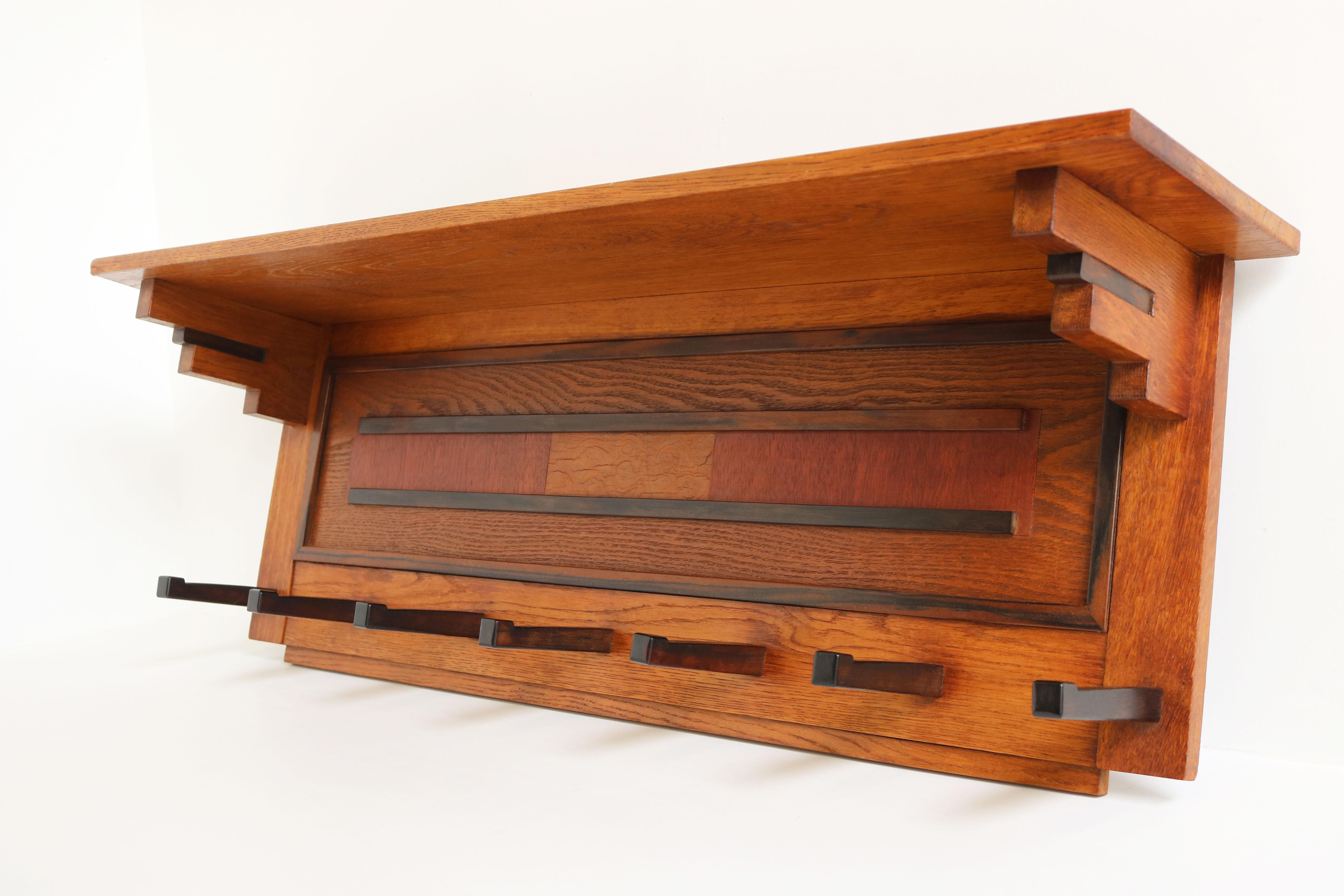 Exquisite clean Dutch Art Deco design coat rack in the Amsterdam School design style by P.E.L. Izeren for Genneper Molen 1920. 
Made from European Oak with gorgeous Macassar & mahogany details. 
For example the square in the coatracks centre made