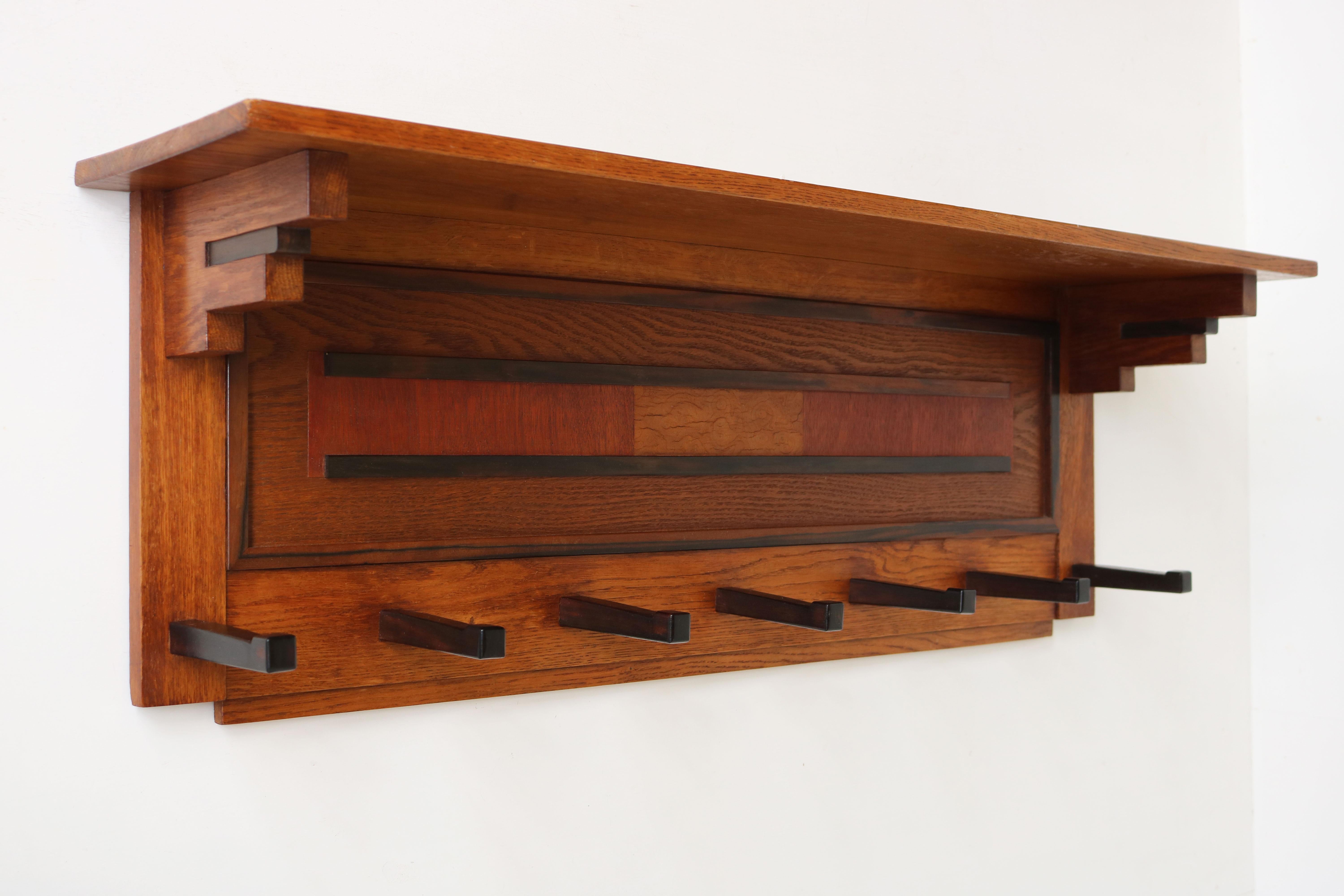 Exquisite clean Dutch Art Deco design coat rack in the Amsterdam School design style by P.E.L. Izeren for Genneper Molen 1920.
Made from European Oak with gorgeous Macassar & mahogany details.
For example the square in the coatracks centre made