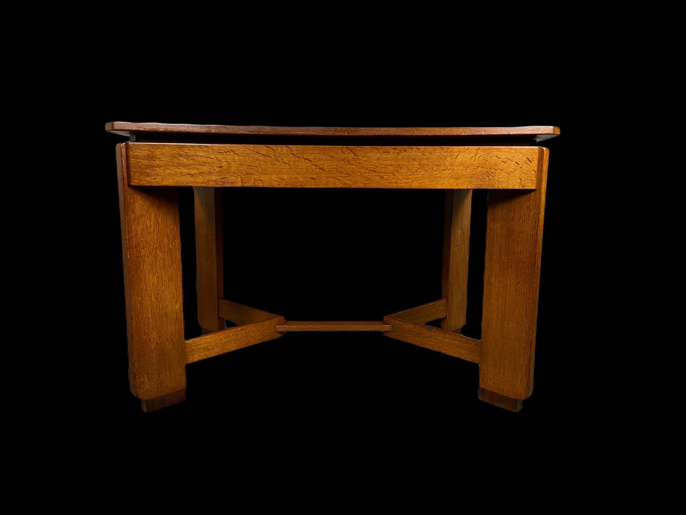 Amsterdam School dining table made of solid oak with under the top of the table a solid coromandel wooden edge. Made by H.Pander (1865-1985)This piece of Dutch design is in good condition but the table top is slightly warped as you can see on the