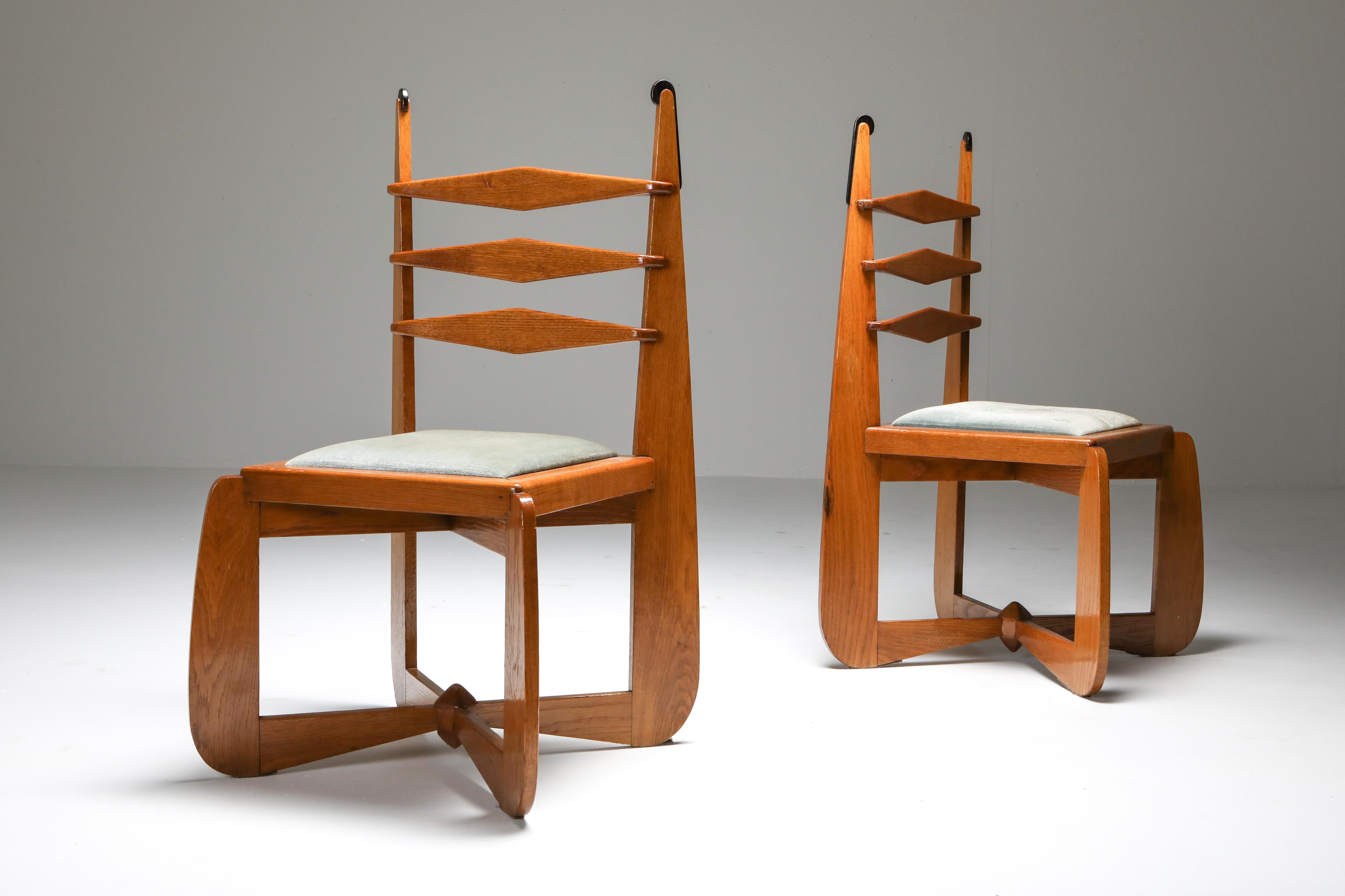 Oak set of expressive chairs in the style of Kramer and Hildo Krop, Netherlands 1930s

Amsterdam School set of six chairs, exuberant and sculptural, with ebonized tips.
The velvet upholstery was already on the chairs, ask about our in house