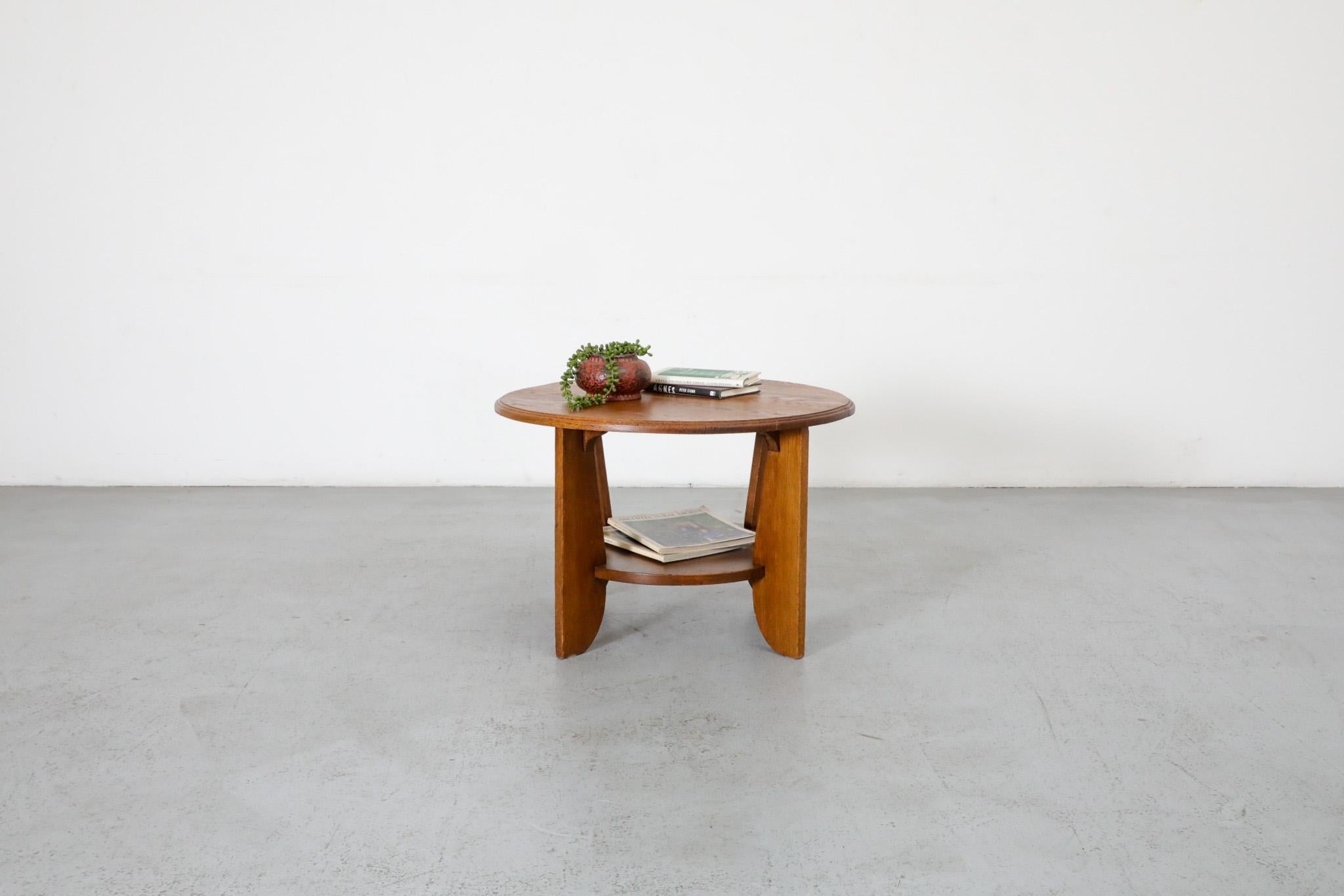 Amsterdam School, Dutch Art Deco, round oak side table, nightstand or plant stand with bottom shelf. In original condition with light scratches and wear consistent with its age and use. Other similar tables available and listed separately.