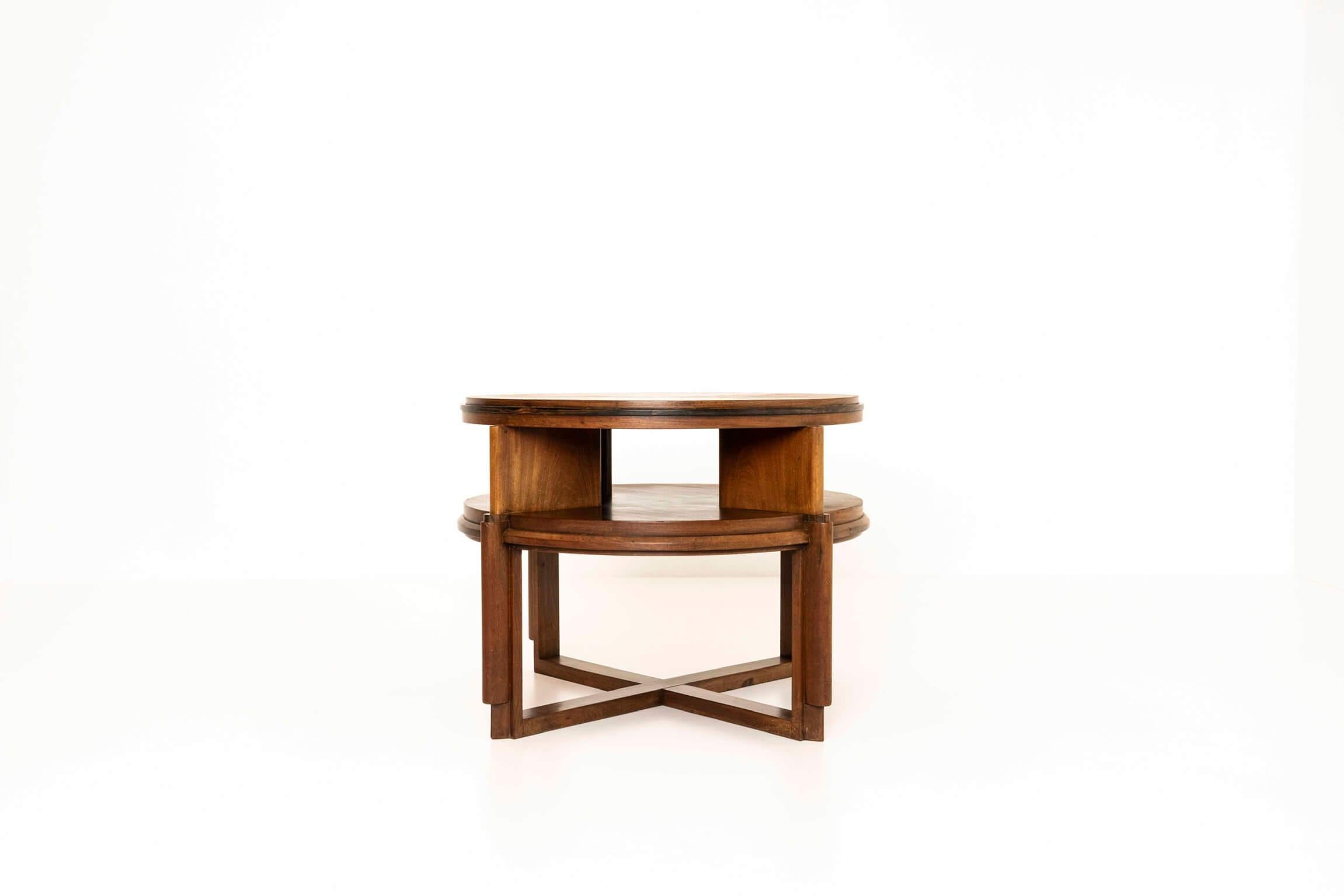 Well-designed Amsterdam School round coffee table from the Netherlands 1930s. This table has a cross-shaped base with two functional layers. The details on the four legs and the top make this a very special table. The top has a beautiful wood