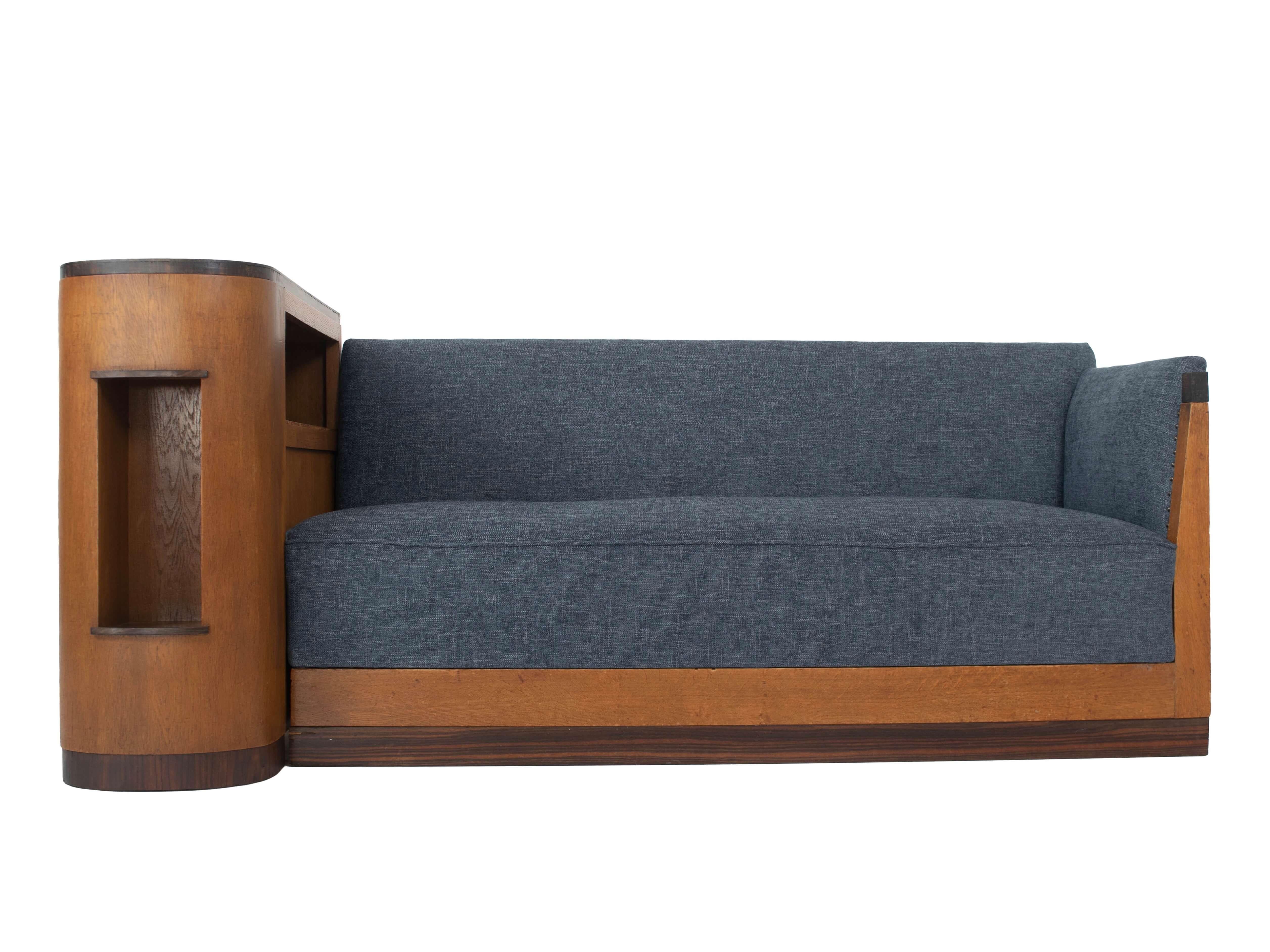 Amazing Amsterdam school sofa or cozy corner from The Netherlands 1930s. This sofa consists of two elements; the left cabinet with storage and the seating area. The base is made of oak and coromandel details. The seating area has been newly