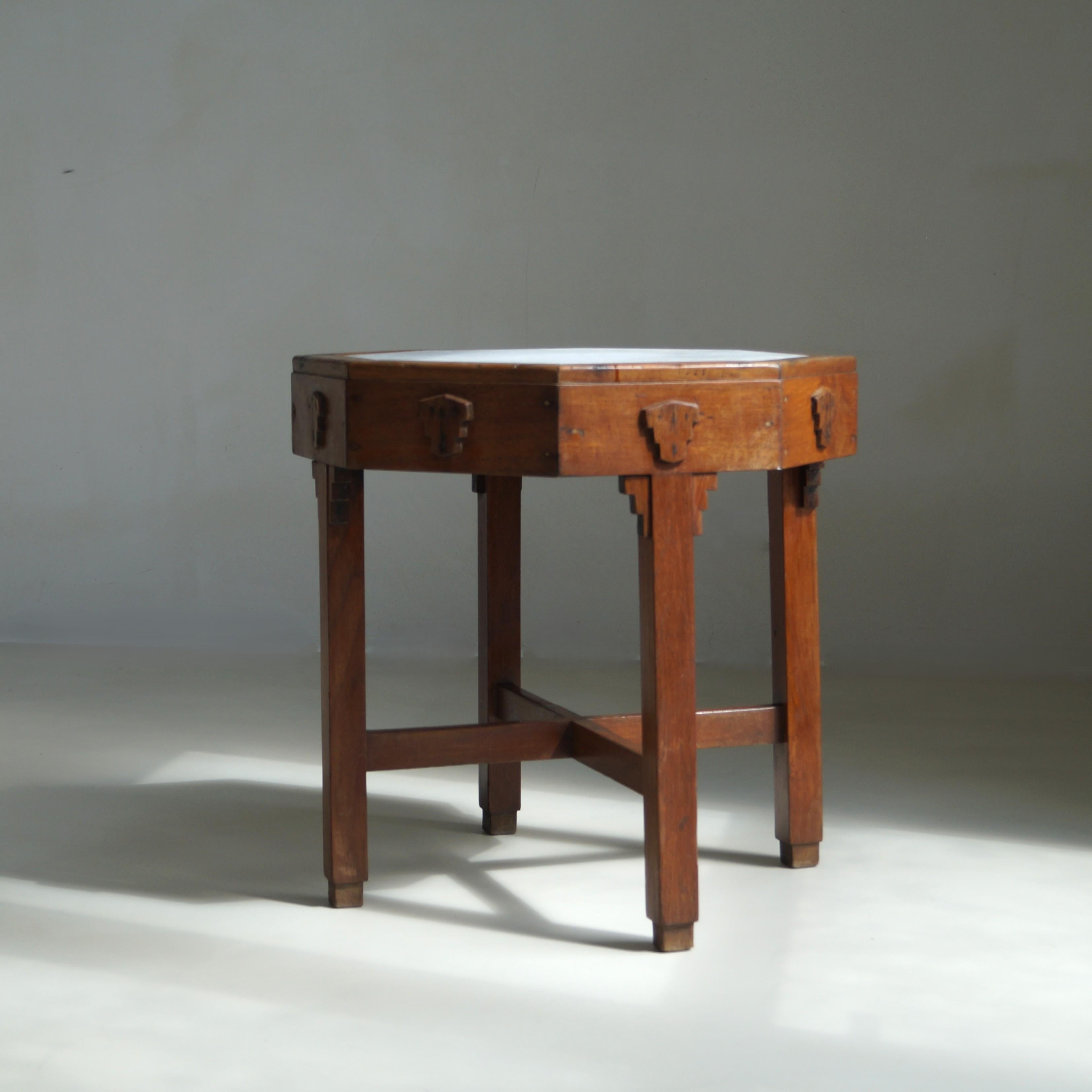 A rare Art Deco teak side table with octagonal white marble inlay, hand crafted in the former Dutch East Indies (Indonesia) by a local carpenter during the late colonial period. Made of solid teak, and speaking the language of Dutch Art