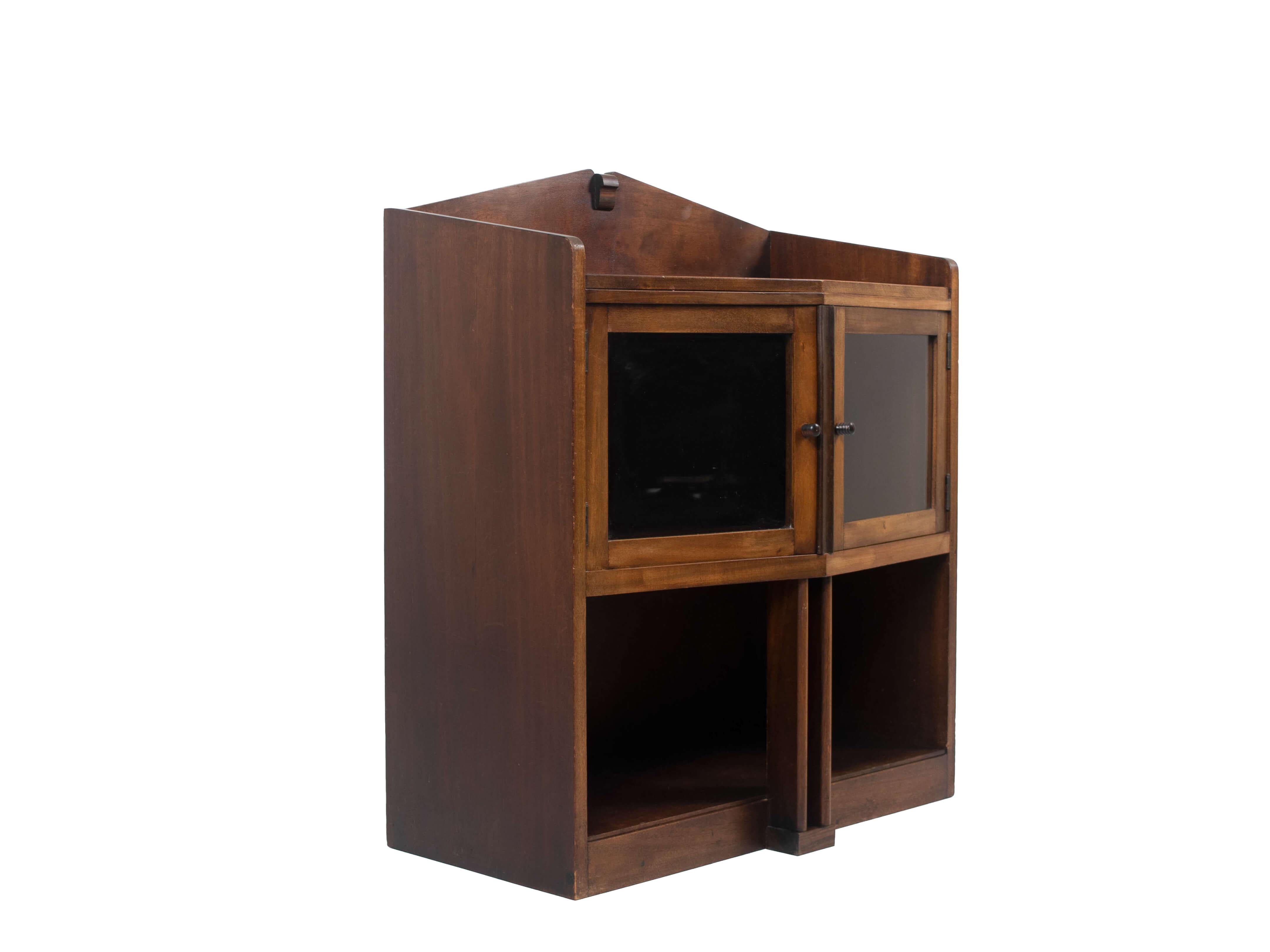 Nice Amsterdam School tea cabinet from The Netherlands 1930s. This cabinet has an attractive design with two glass doors on top and a shelve on the bottom. It has recognizable details for Dutch Design in the Art Deco period. The cabinet is in good