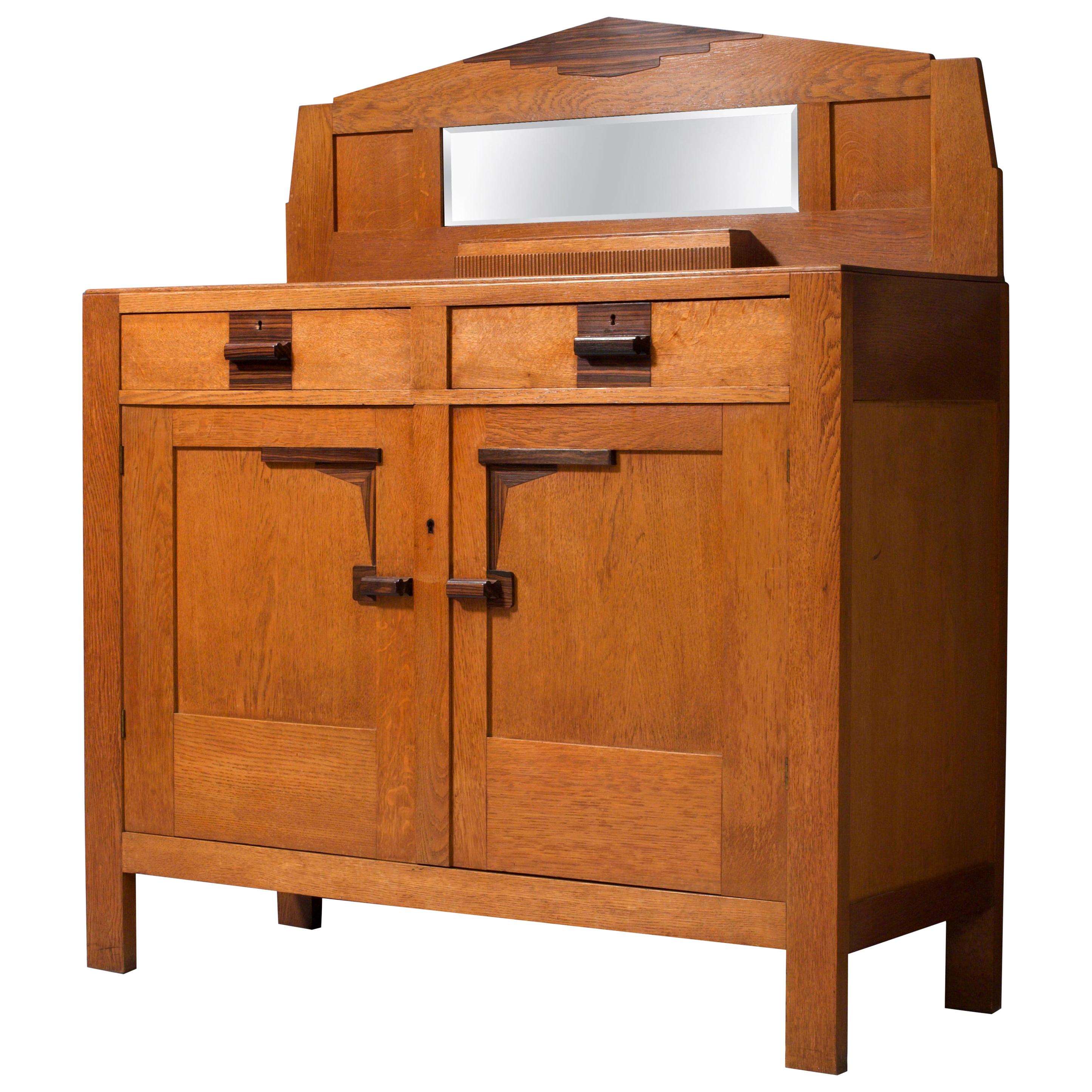 Very well preserved Art Deco bar cabinet from the late 1920s. This high cabinet has a lot of typical details from the Dutch Amsterdamse School Period, that was predominantly an architectural influence in that period. Lot's of houses here in