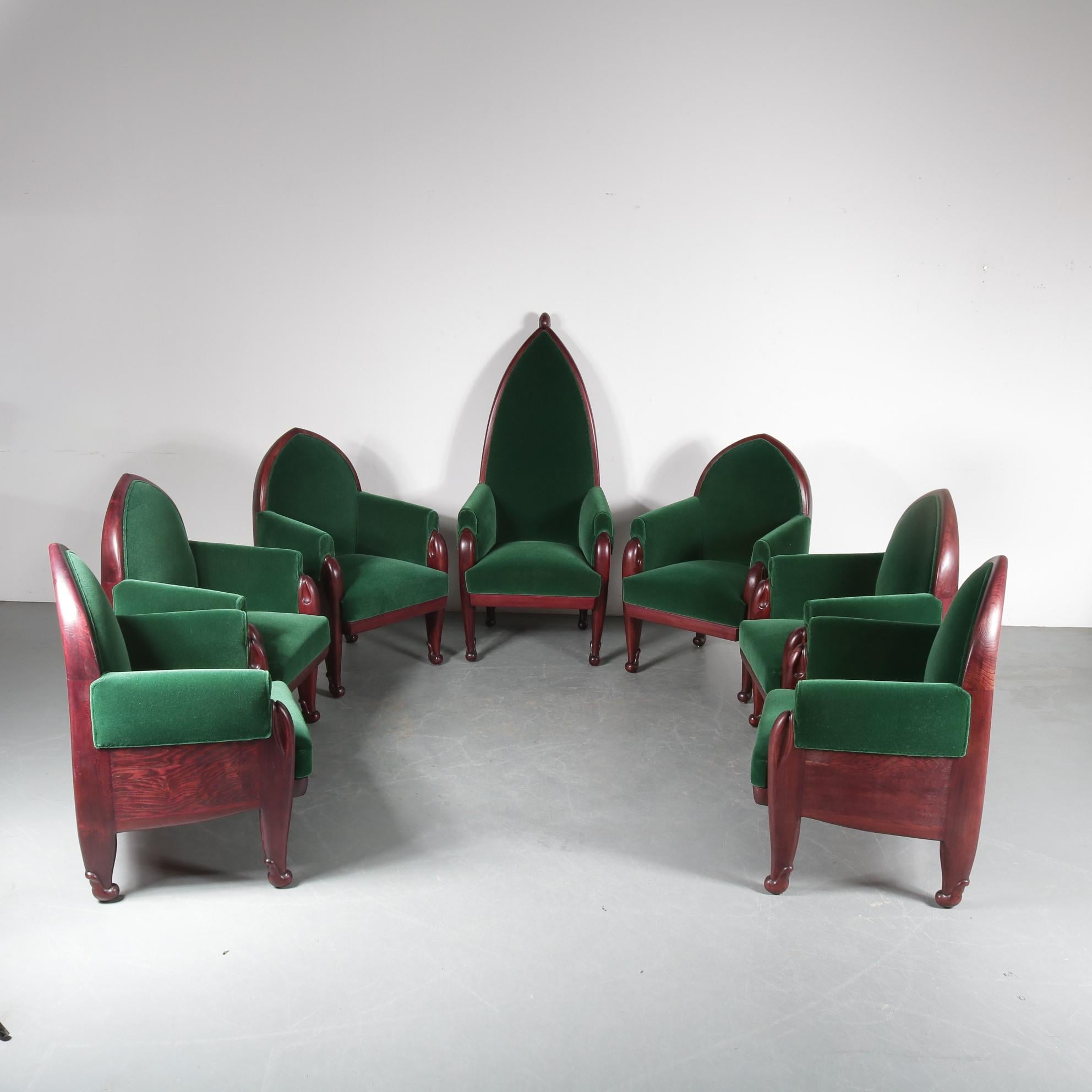 An impressive set of seven conference chairs in Amsterdamse School style, designed by Cornelis Blaauw for the School of Applied Arts in Haarlem around 1920.

They are made of beautiful quality wood with a warm brown finish. The chairs have a