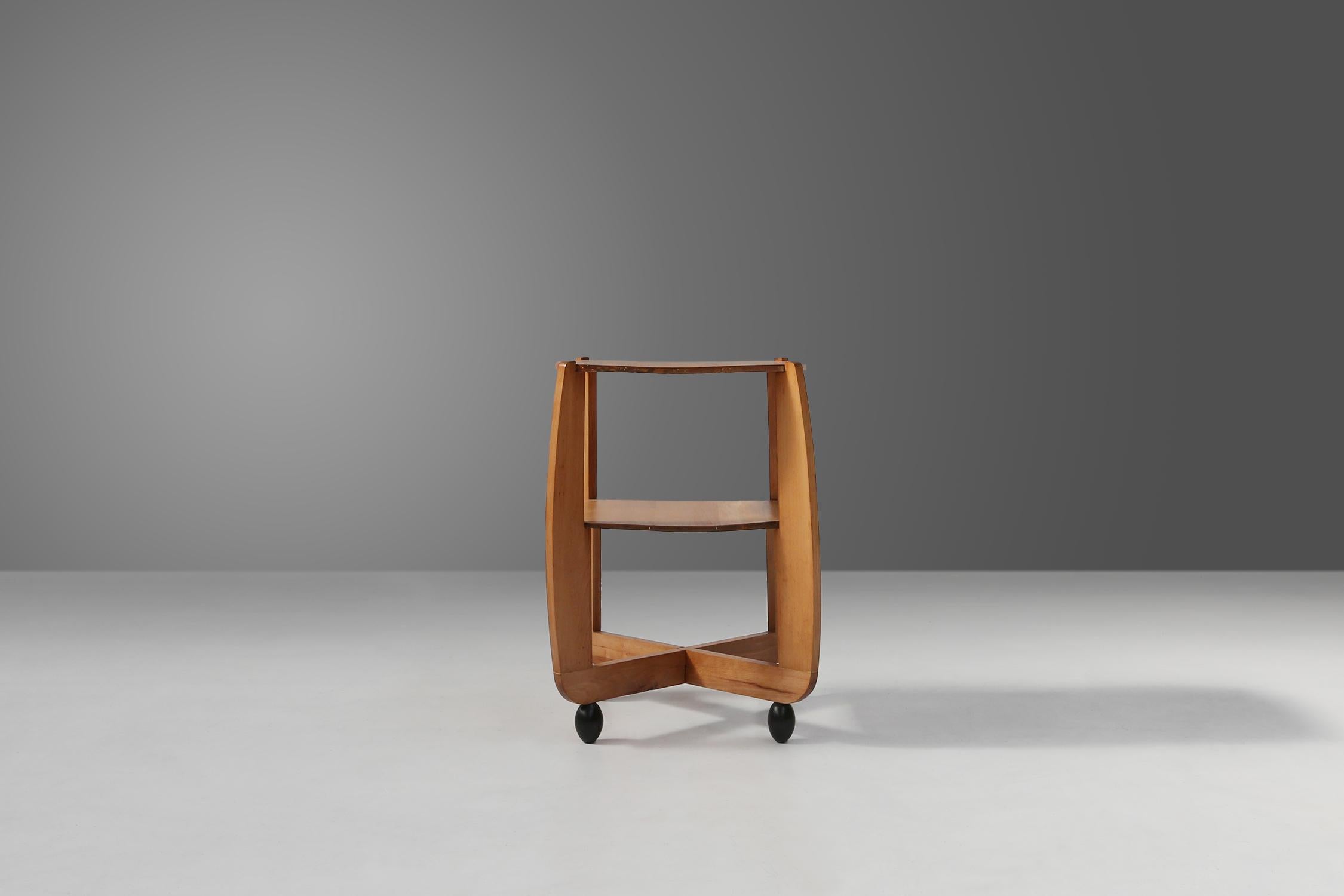 This side table is an authentic piece from the 1920s, made in the Amsterdam School style. This style is characterized by the use of geometric shapes, expressive lines and rich materials. The side table is made of beech wood, a durable and natural