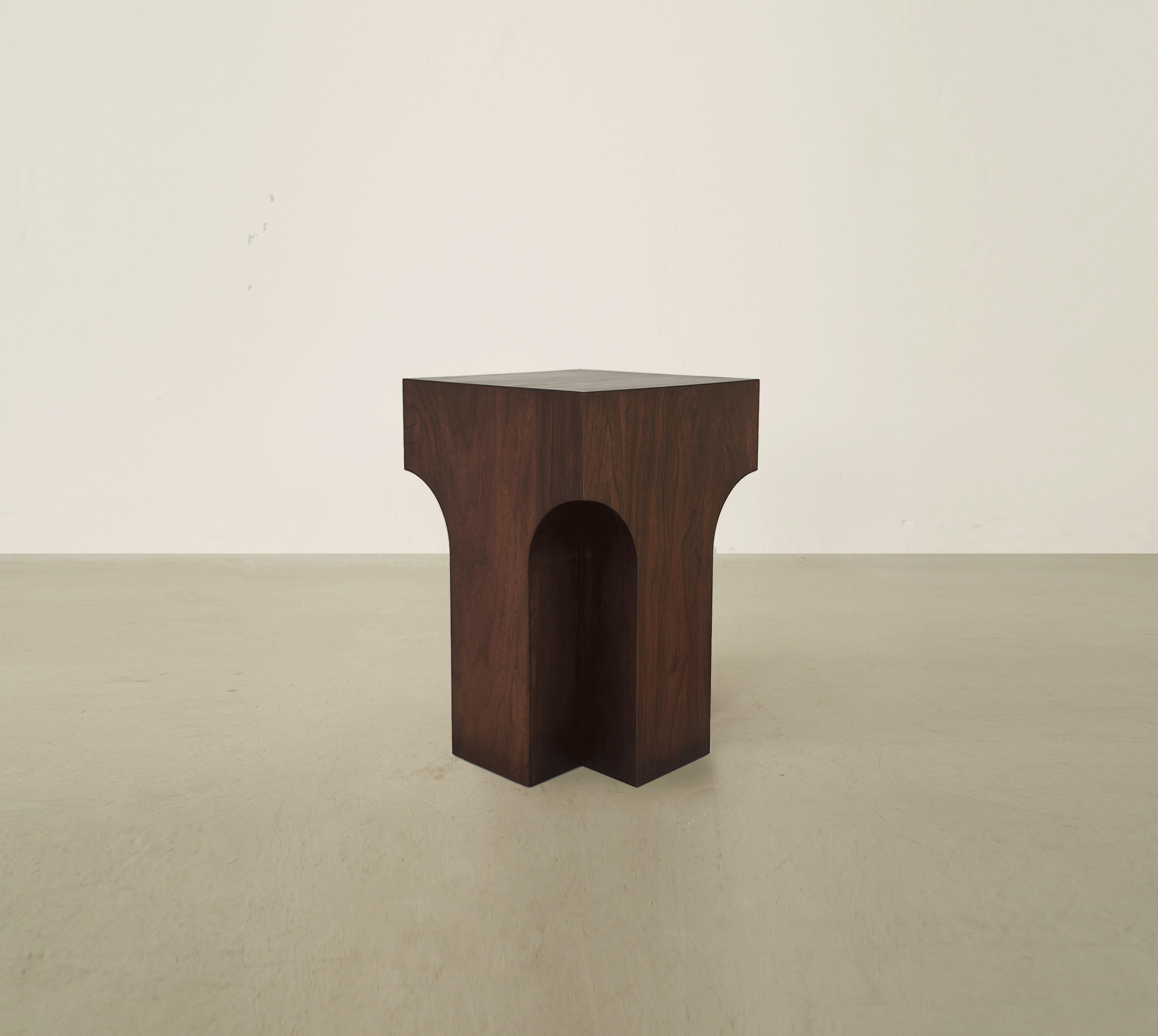 Amud Side Table by Selma Lazrak
Dimensions: D 32 x W 32 x H 46 cm 
Materials: Solid American walnut.

The piece is inspired by the architecture of the columns founded in the city of Fez in Morocco.
The chamfered edges of the pillars are inspired by