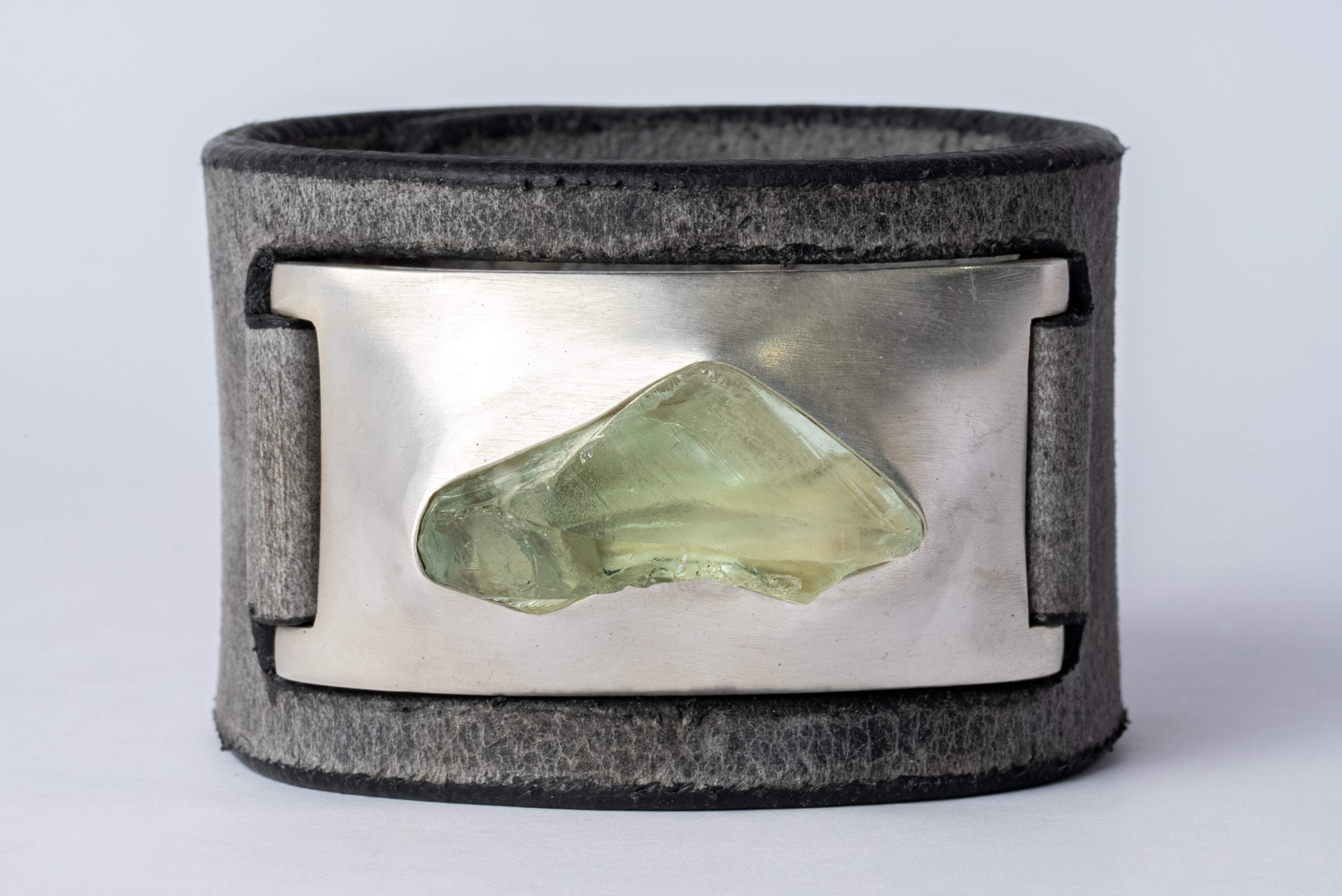Bracelet in acid treated silver plated brass, green amethyst, and grey shingles leather. This item is made with a naturally occurring element and will vary from the photograph you see. Each piece is unique and this is what makes it special.
Bracelet