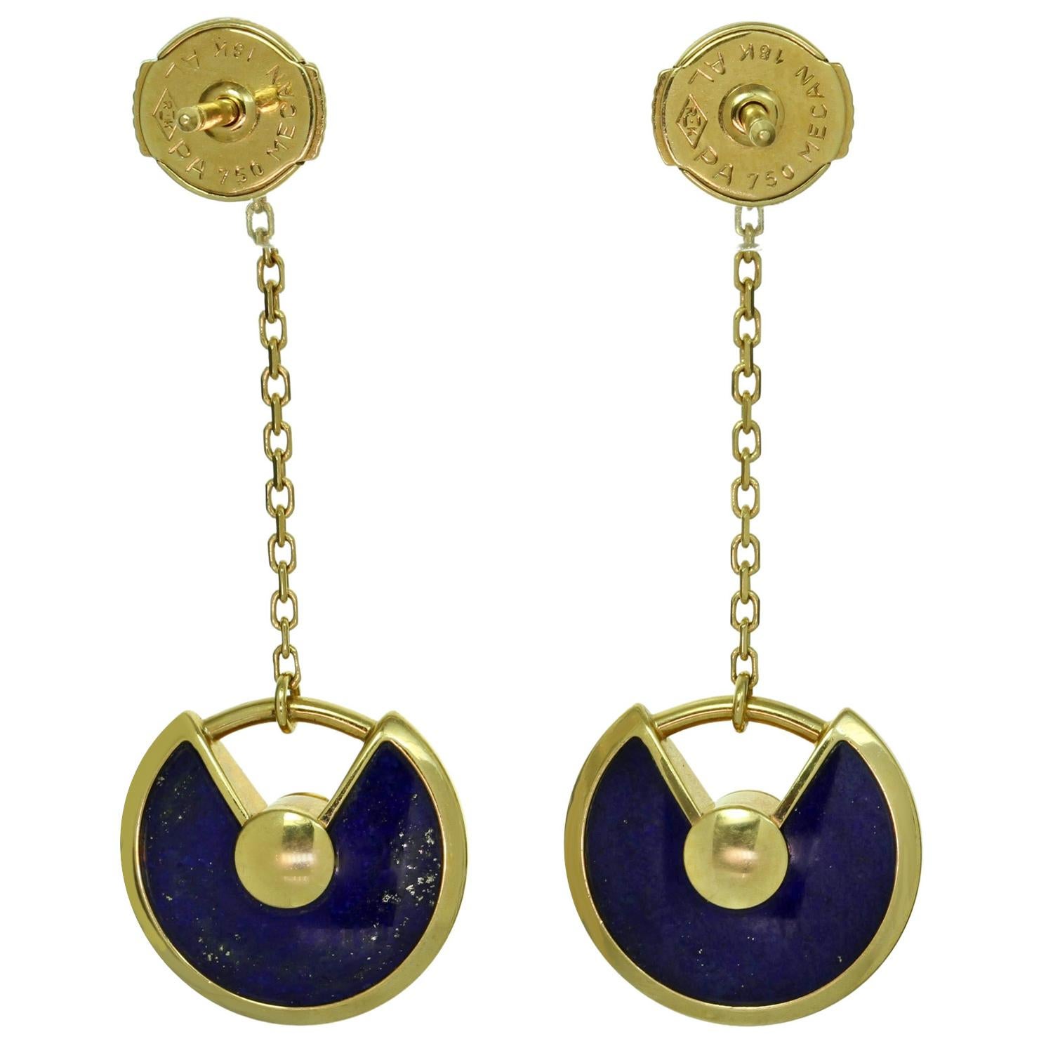 These gorgeous earrings from the Amulette de CARTIER collection are crafted in 18k yellow gold and feature dagling lapis lazuli discs suspended from bezel-set solitaire diamonds and accented with a brilliant-cut round diamonds in the center. The D-F