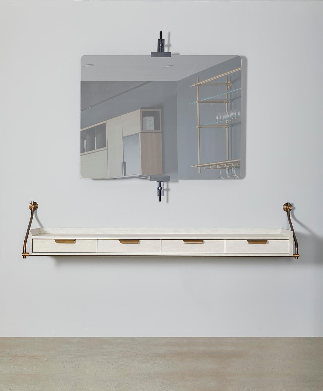 Amuneal’s wall hanging bleached oak console table uses our traditional Collector’s Shelving hardware to support this four-drawer unit with vintage bronze metal details and raised knife-edge surround. The scale of the unit and its unique floating