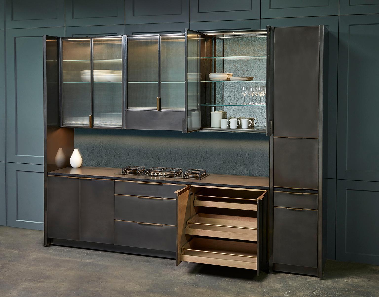 Amuneal’s gunmetal kitchen is a fully bespoke kitchen system that blends individual functionality with Minimalist detailing. The interior cabinetry is fabricated from solid wood and handcut veneers offering the highest quality traditional