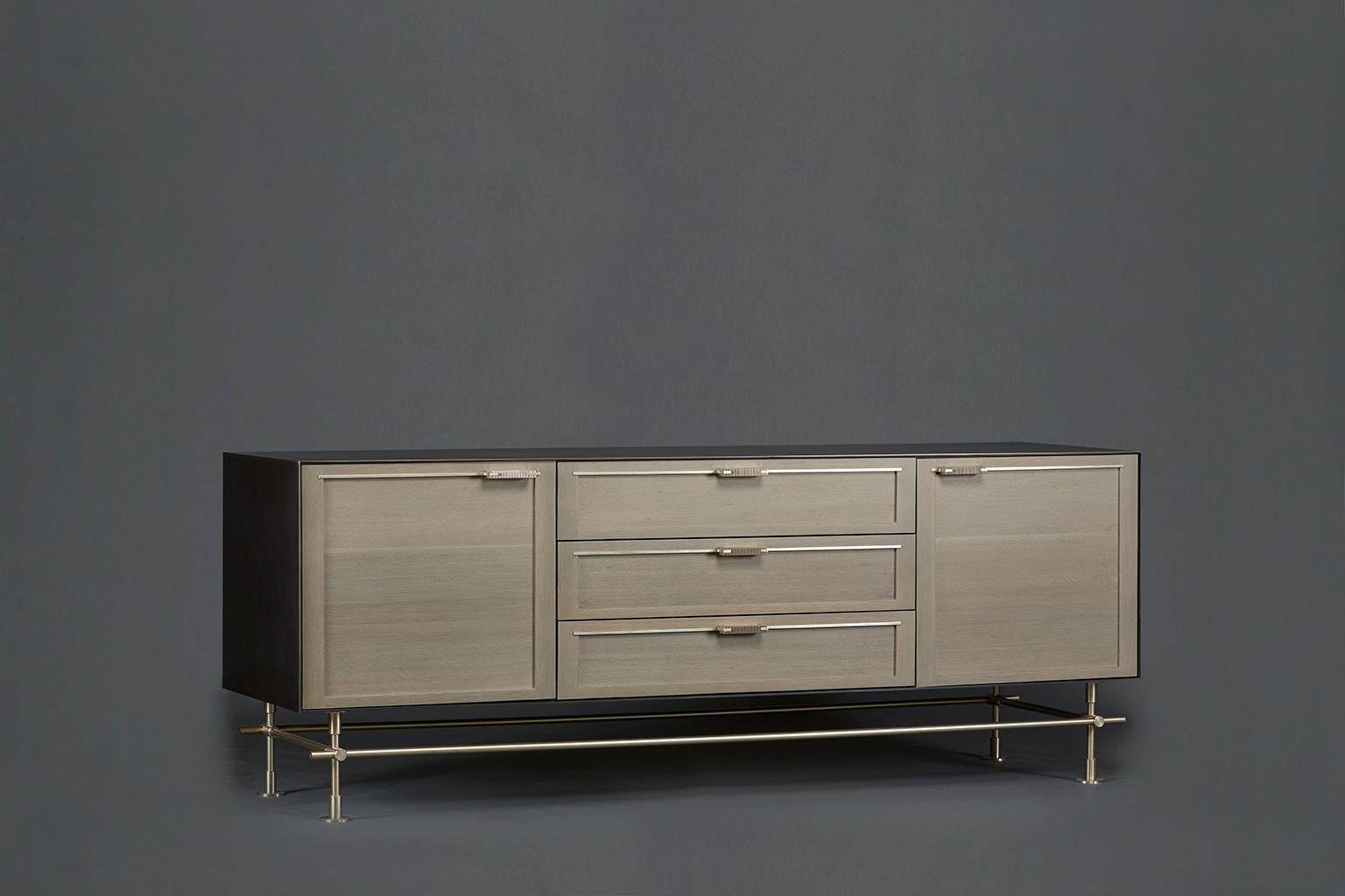 This Maker sideboard is the perfect addition to a dining room, bedroom, kitchen or banquet hall. With an outer cladding of solid blackened steel, the white oak door and drawer faces are finished in a soft, weathered gray. The balance of hard and