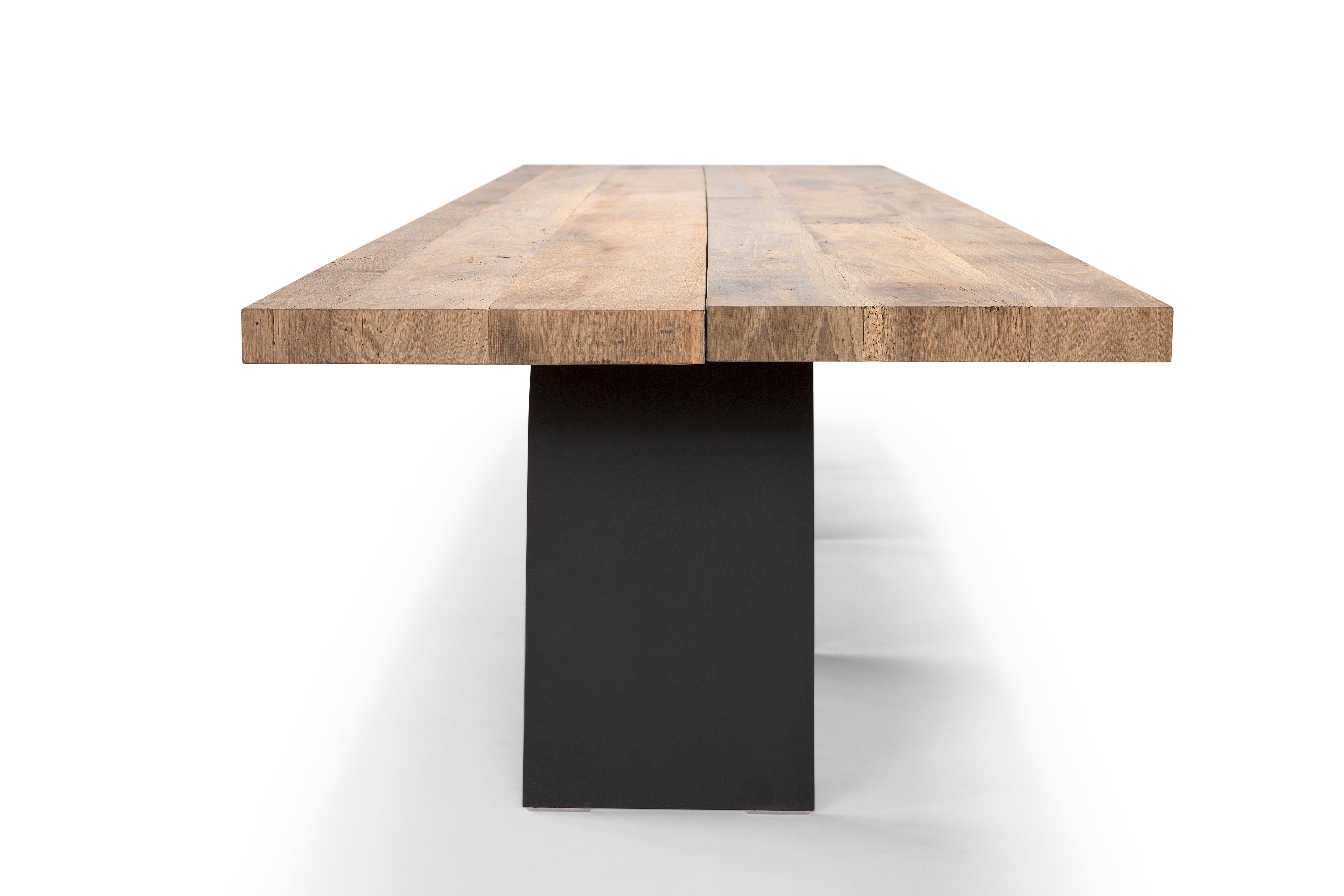 Table made in multiply with a 1 cm. veneer of antique reclaimed oak, aged between 80 and 350 years, left in a raw state, ancient, where veins, cracks, knots and imperfections become the specific and characterizing feature of this table. At a first