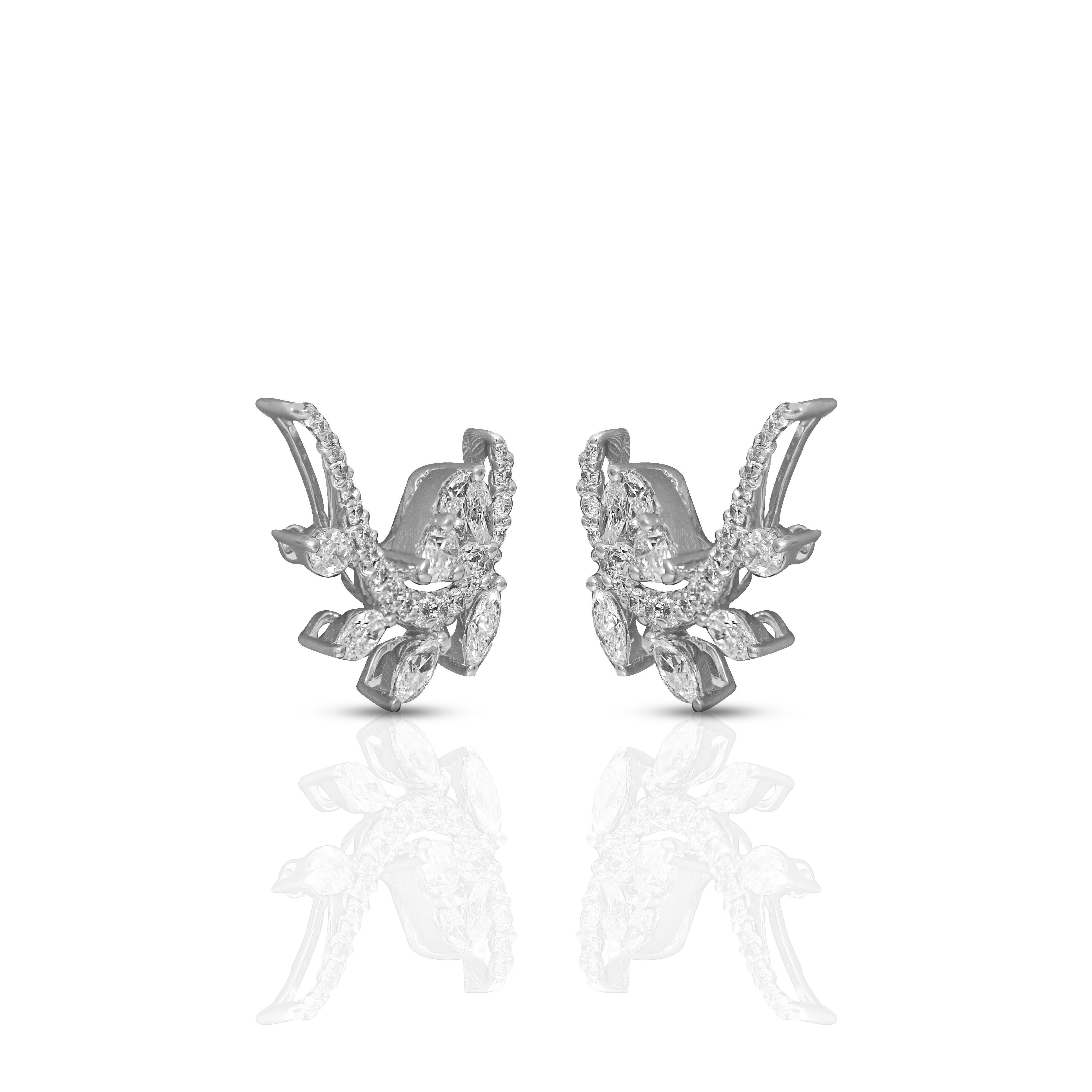 A creative arrangement of pear shape, marquise, and round cut diamonds set in 18 karat white gold that creates an imaginative motif for these earrings. Each diamond is set individually by hand within a minimal metal setting to allow its sparkle to
