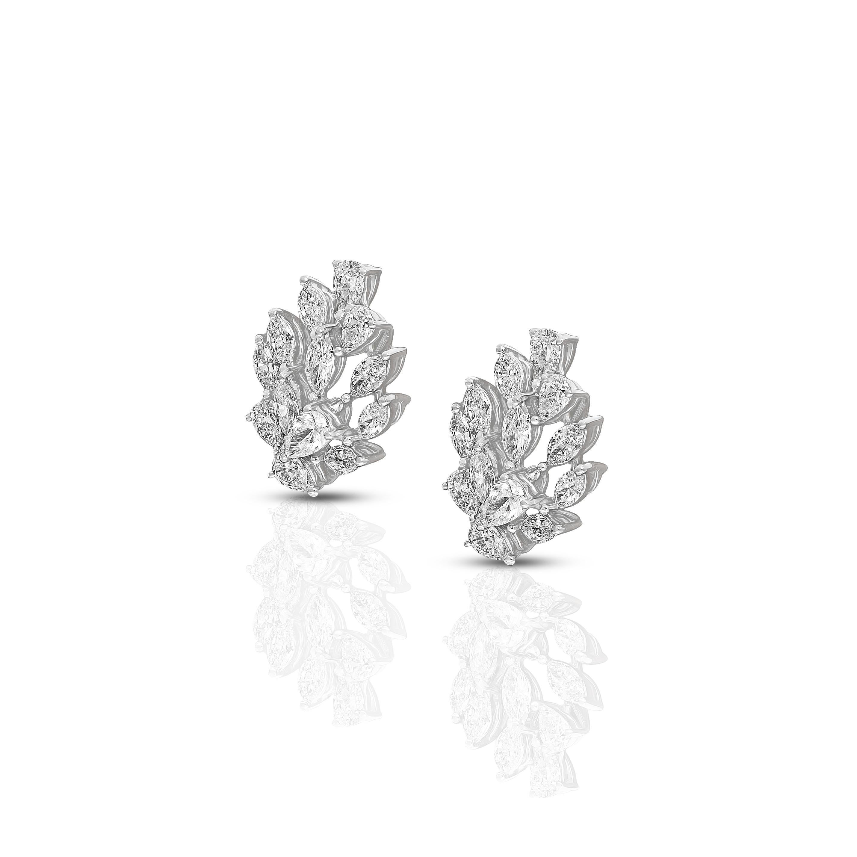 This contemporary pair of 18 karat white gold earrings feature cascade of pear and marquise cut diamonds that are artfully arranged to create a leaf motif.  The gold and diamond earrings showcase the beauty of two classic diamond cuts. 
18 Karat