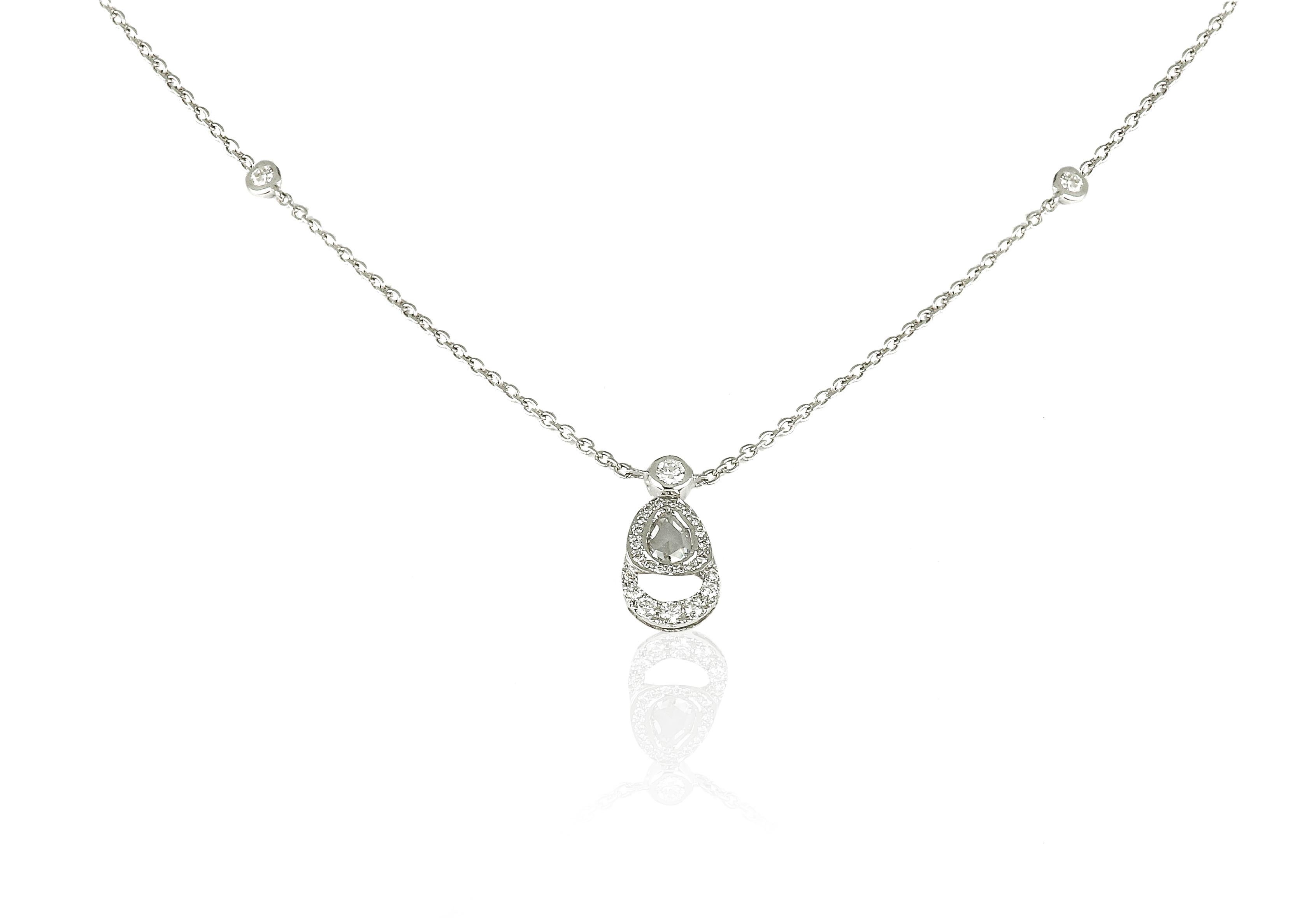 There is incredible classiness in the purest of designs. Amwaj 18 karat white gold pendant from the palm tree collection features rose cut diamond, surrounded by a medley of small round diamonds. This gold pendant highlights the ultimate