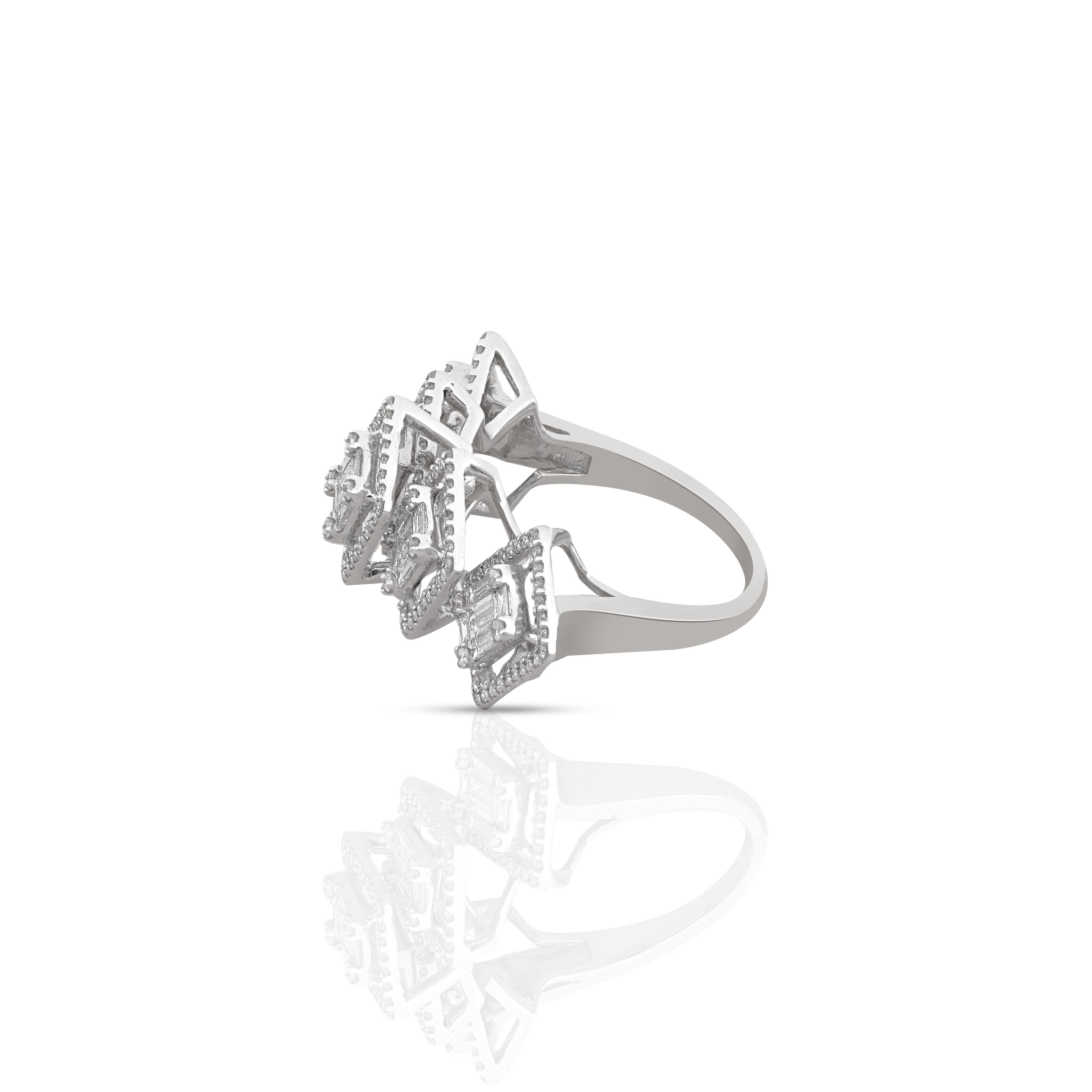 Amwaj 18 karat white gold and diamond ring features a charming quintet of baguette diamonds. Each of the 2 side stones is gently angled to embrace the finger and catch and reflect the light. Subtly surrounded by small round diamonds, the setting of