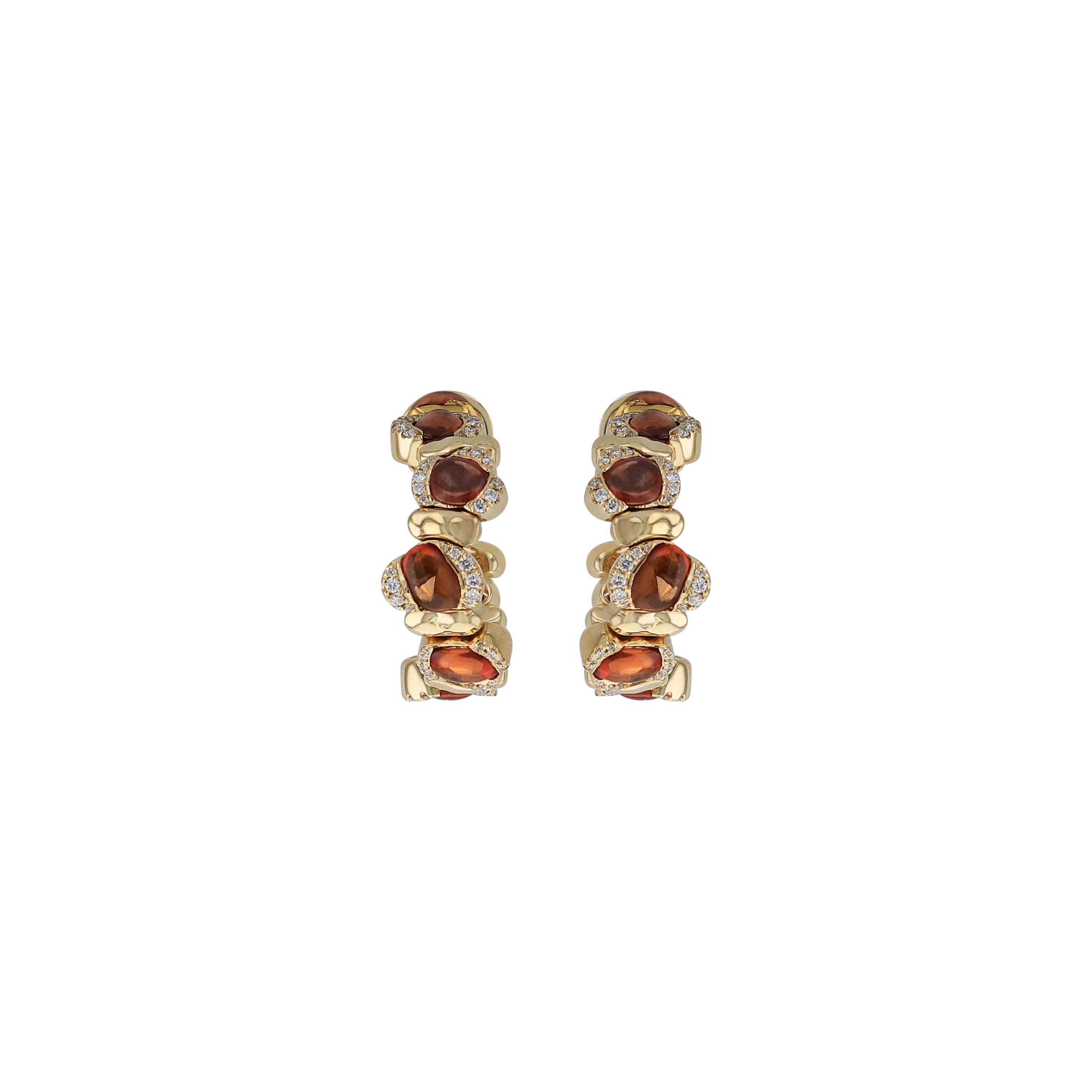 Delicate, swirling earrings in 18 karat yellow gold and orange sapphires that loop elegantly around the ear, Amwaj mini signature earrings showcase the artistry of our designers who position each pave stone by hand. 
18 Karat Yellow Gold
19.86 g
