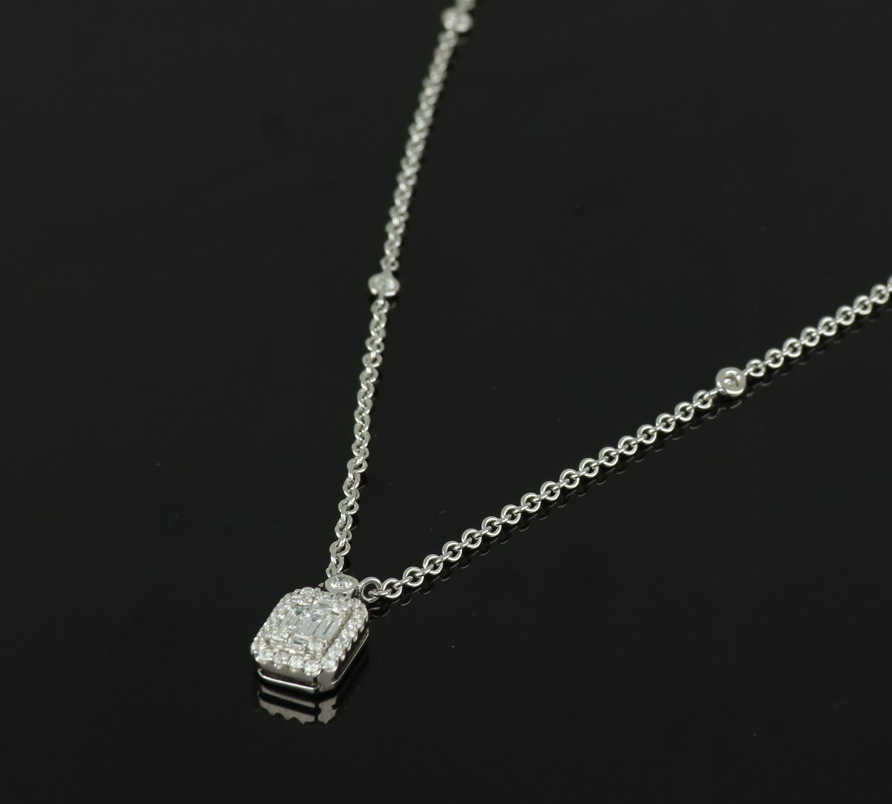 This exquisite 18 karat white gold pendant by Amwaj jewellery features a carat diamond, showcasing the architectural beauty of an emerald cut, set upon a delicate and sleek white gold chain and surrounded by a halo of round diamonds. 
Diamonds