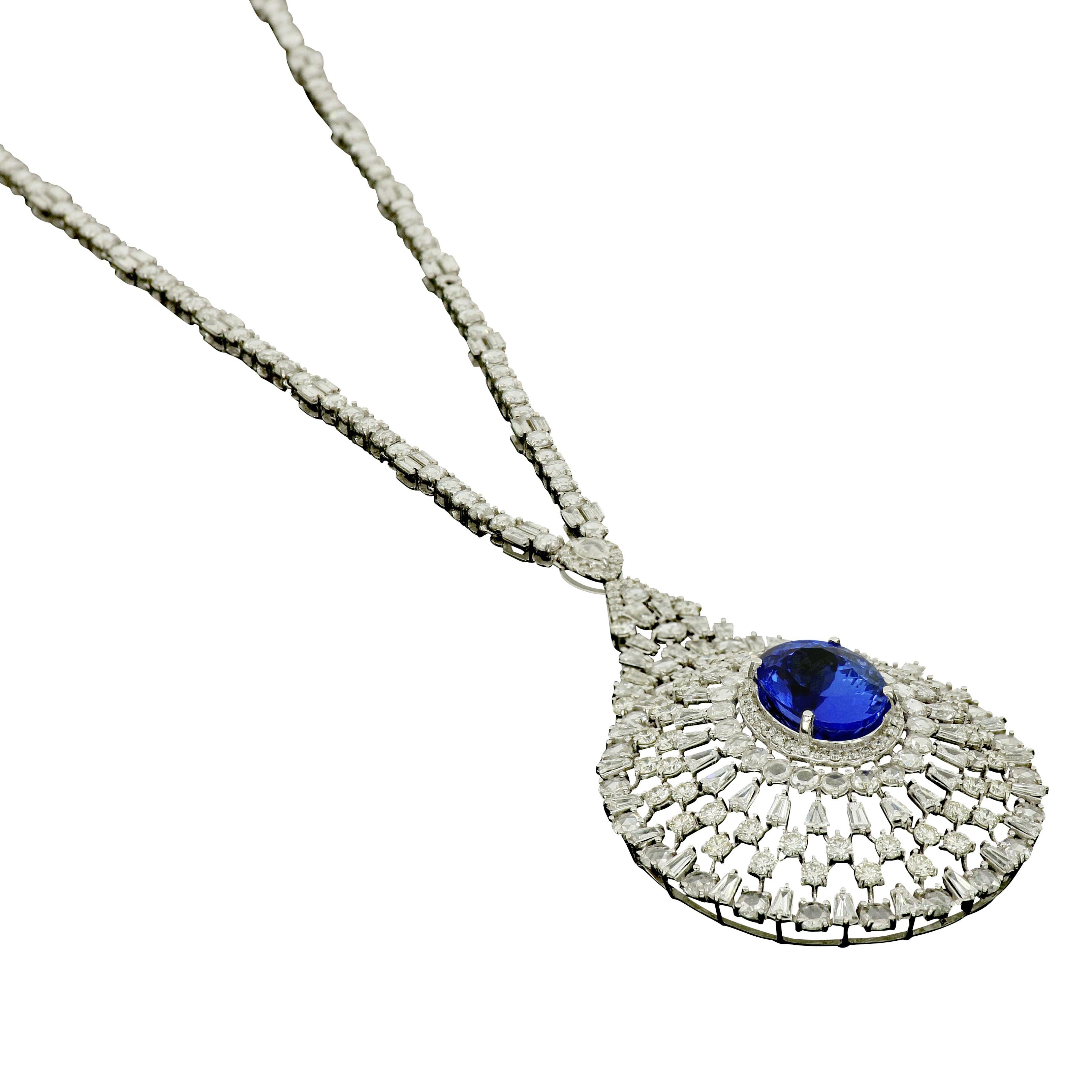 Suspended from round, trapeze and rose cut diamonds chain, Amwaj classic chandelier necklace in 18 karat white gold features multi cut diamonds grouped by oval purple tanzanite, set to form an elegant eyes motif, bringing their delicate, graceful