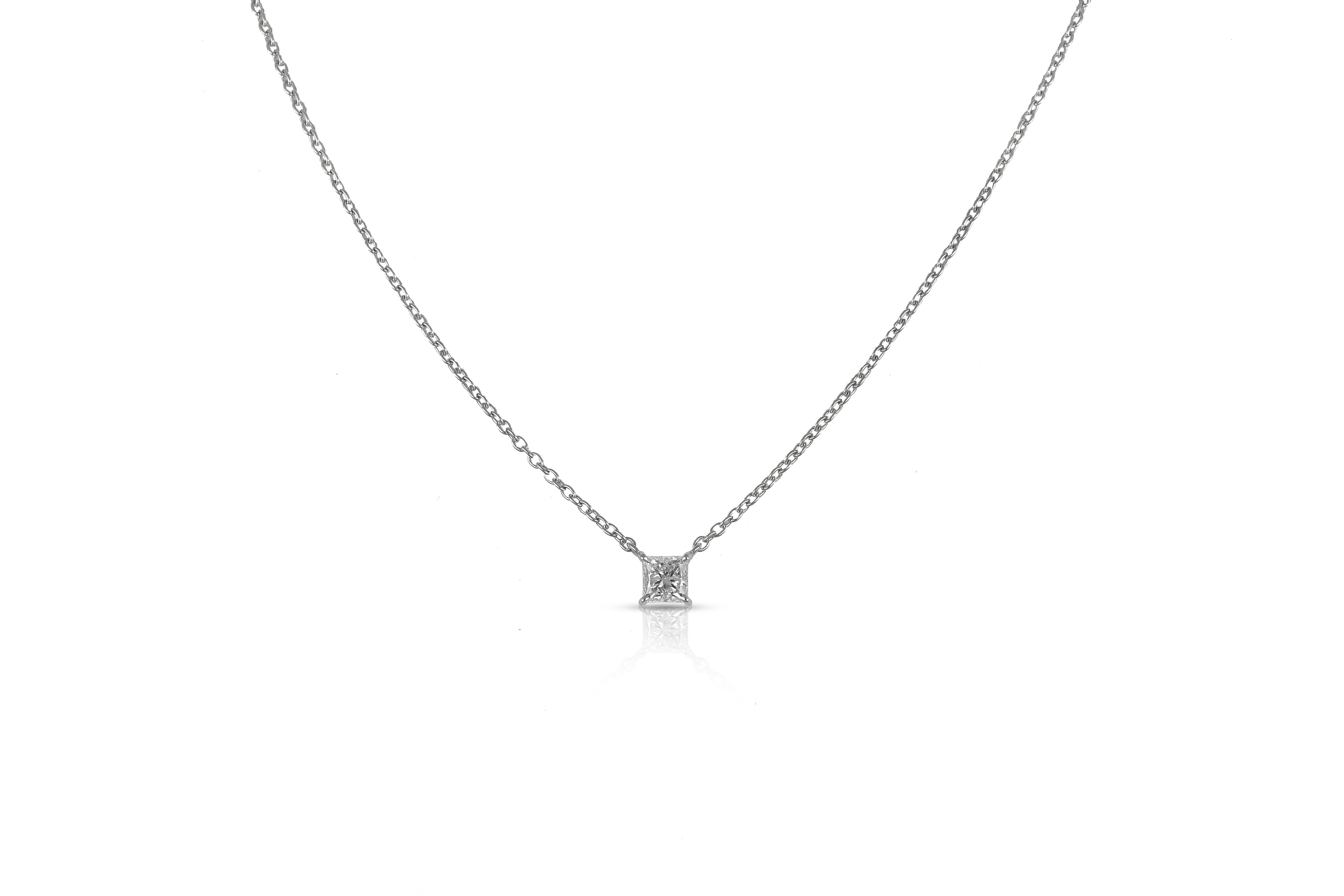 This truly enduring 18 karat gold pendant set with a princess cut diamond demonstrates the exceptional quality and refinement which makes it perfect for both daywear and eveningwear. Suspended from a fine white gold chain, the centerpiece stone