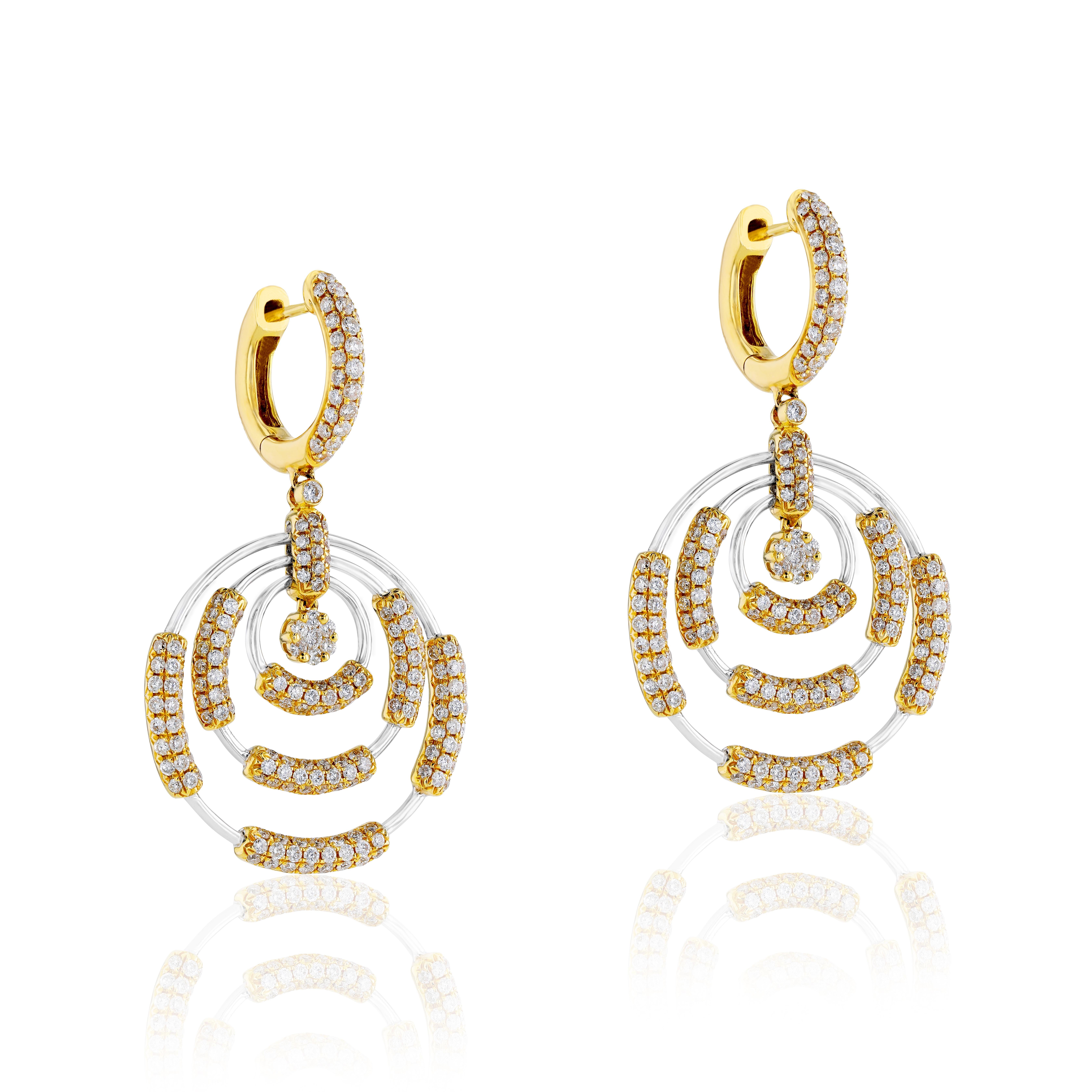 These timeless gold earrings from Amwaj Jewelry feature two round diamonds weighing 3.7 carats which form the centrepiece of the classically elegant 18 karat white gold earrings, framed by a radiant halo of yellow gold and small round white