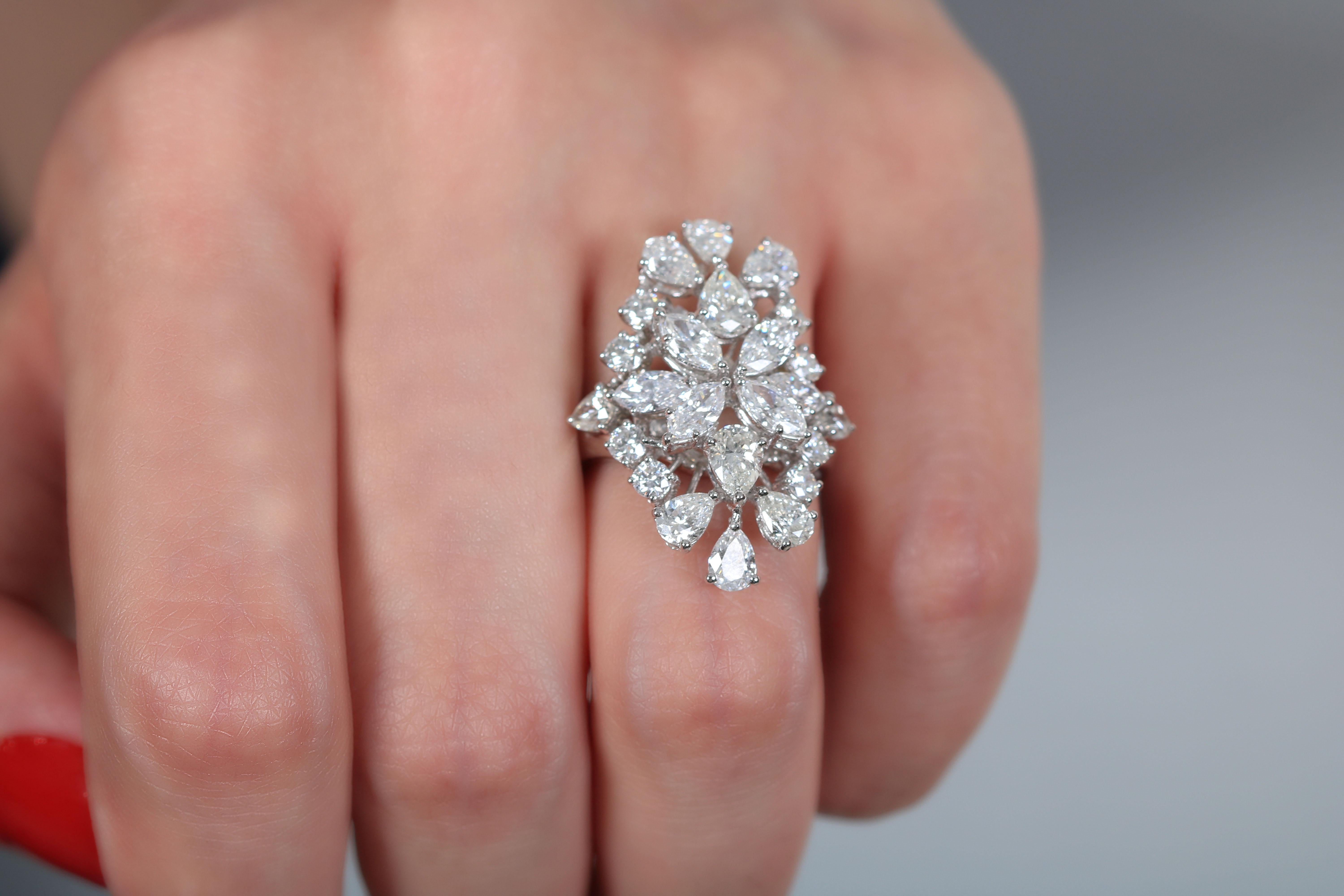 A Classic Beauty. This 18 Karat white gold ring by Amwaj Jewelry features 4.78 carat pear shape diamonds that sit ever so beautifully and are enhanced by the round diamonds. 

Diamond Clarity: VS SI / G H COLOR
Diamonds (Total Carat Weight: 4.78 ct)