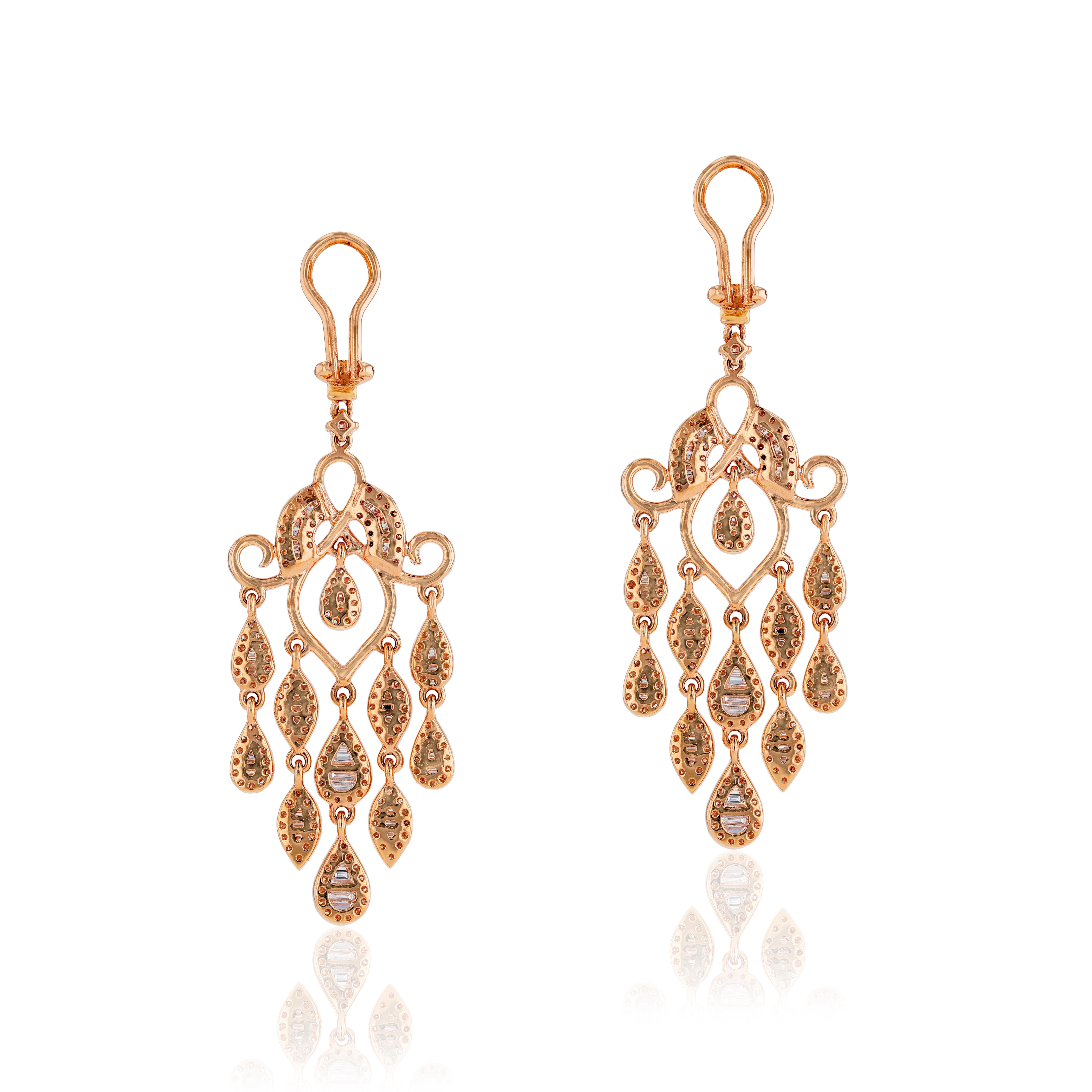 The sleek lines and striking color of 3.77 carats of white diamonds is showcased in these luxurious chandelier rose gold earrings by Amwaj Jewelry. Suspended from each piece, five articulated rows of round and baguette cut white diamonds. 
Diamonds
